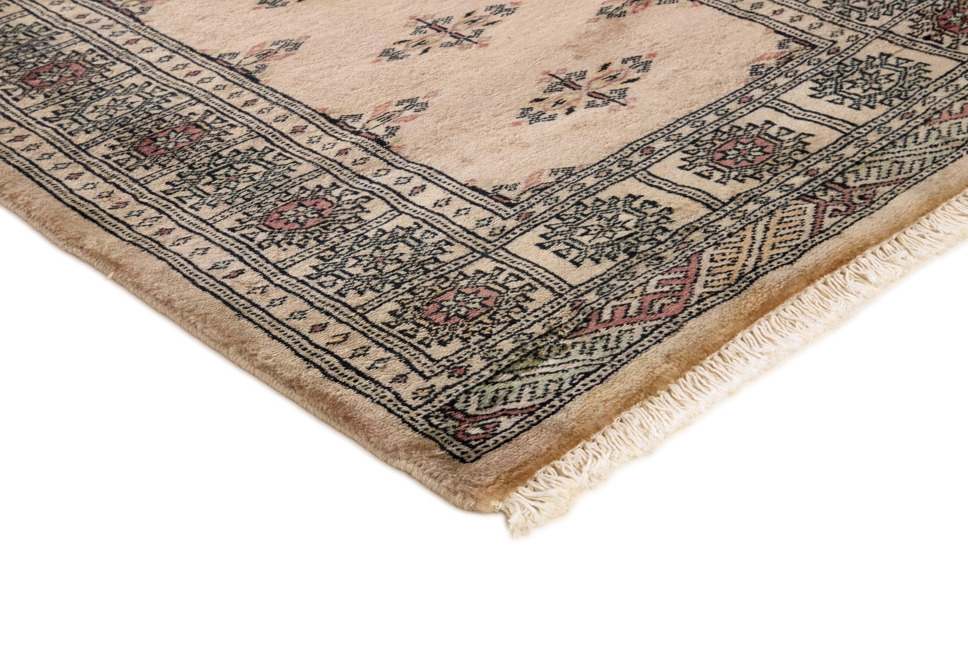 Beige Oriental rug with traditional bordered pattern