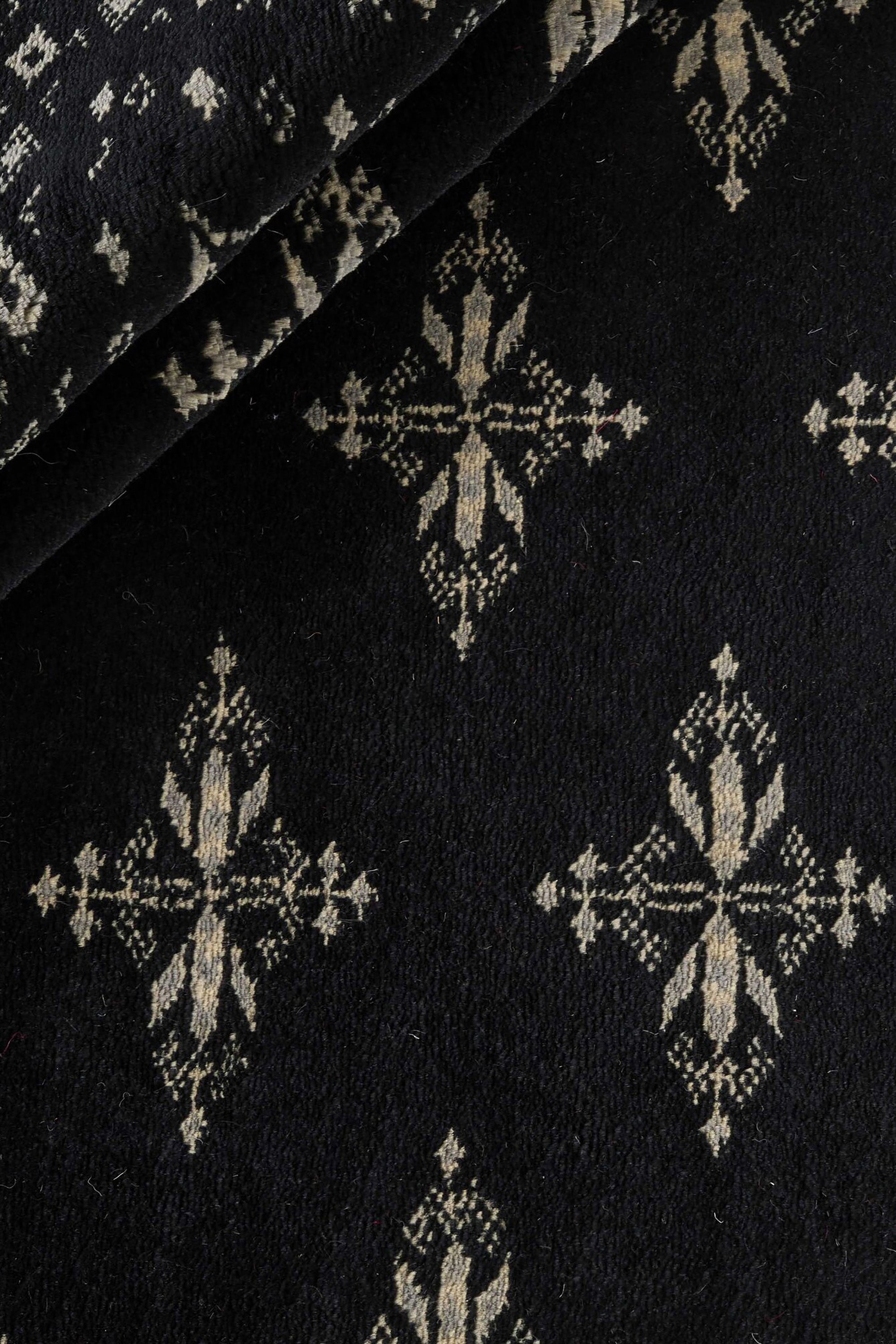 Black Oriental rug with traditional bordered pattern