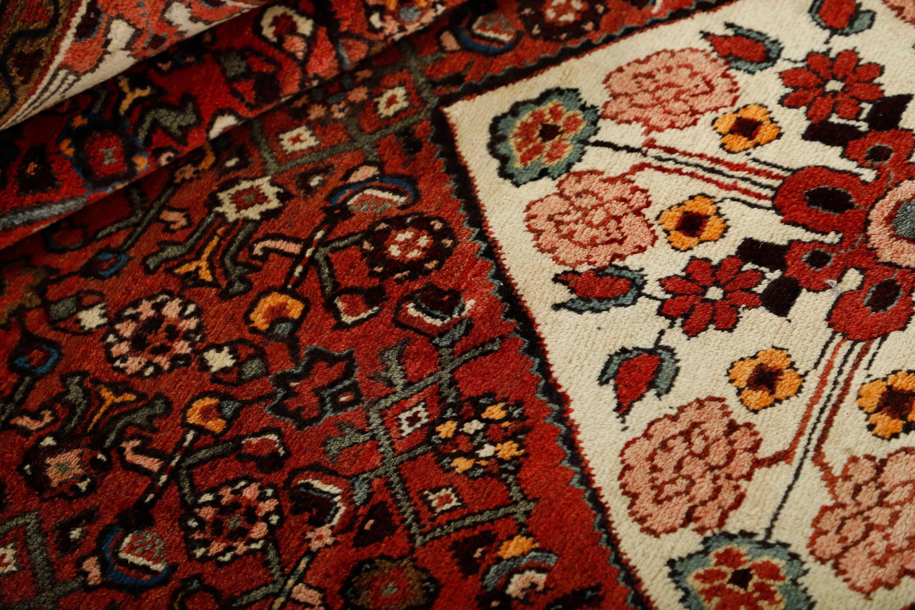 Red and black traditional persian rug with floral design