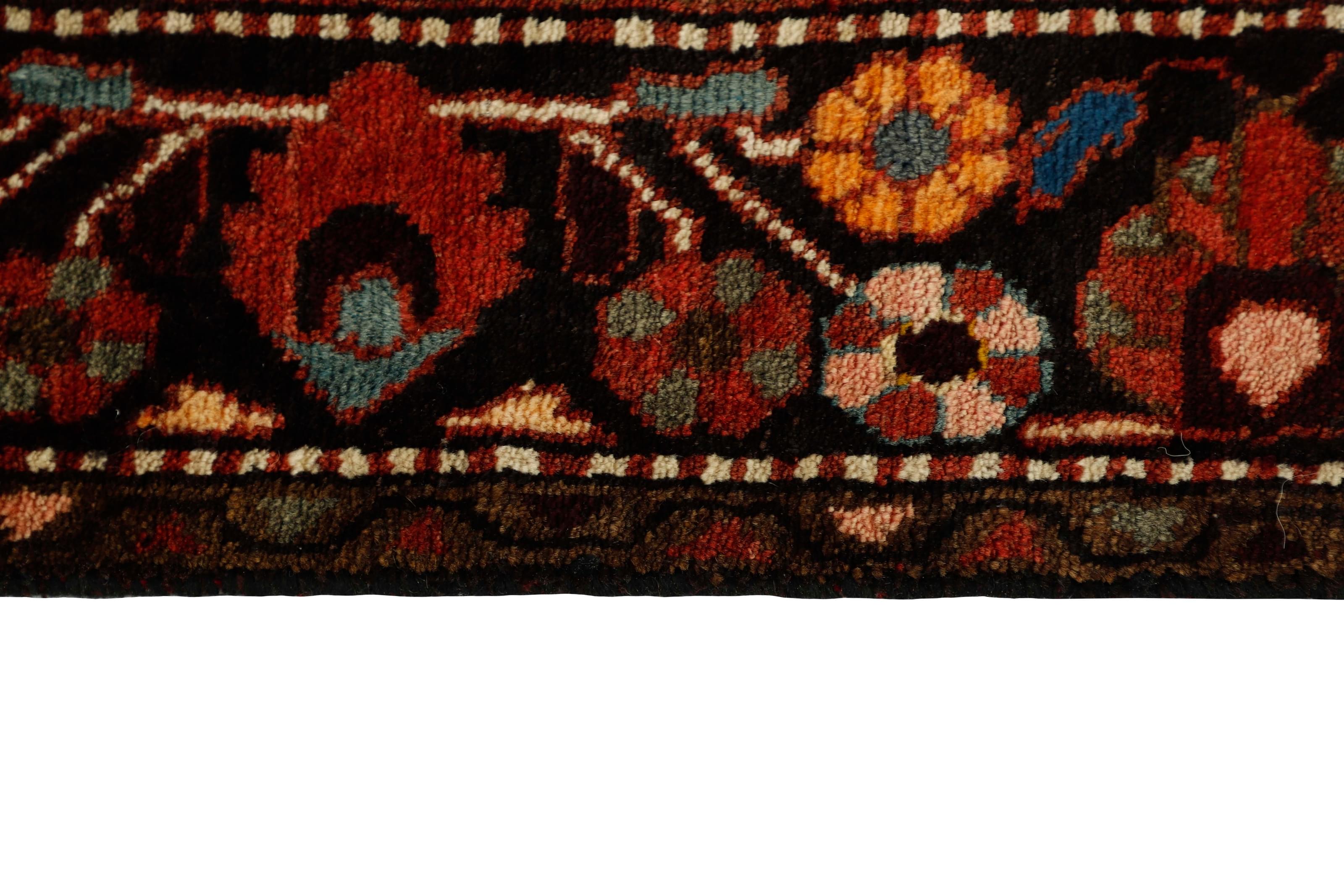 Red and black traditional persian rug with floral design