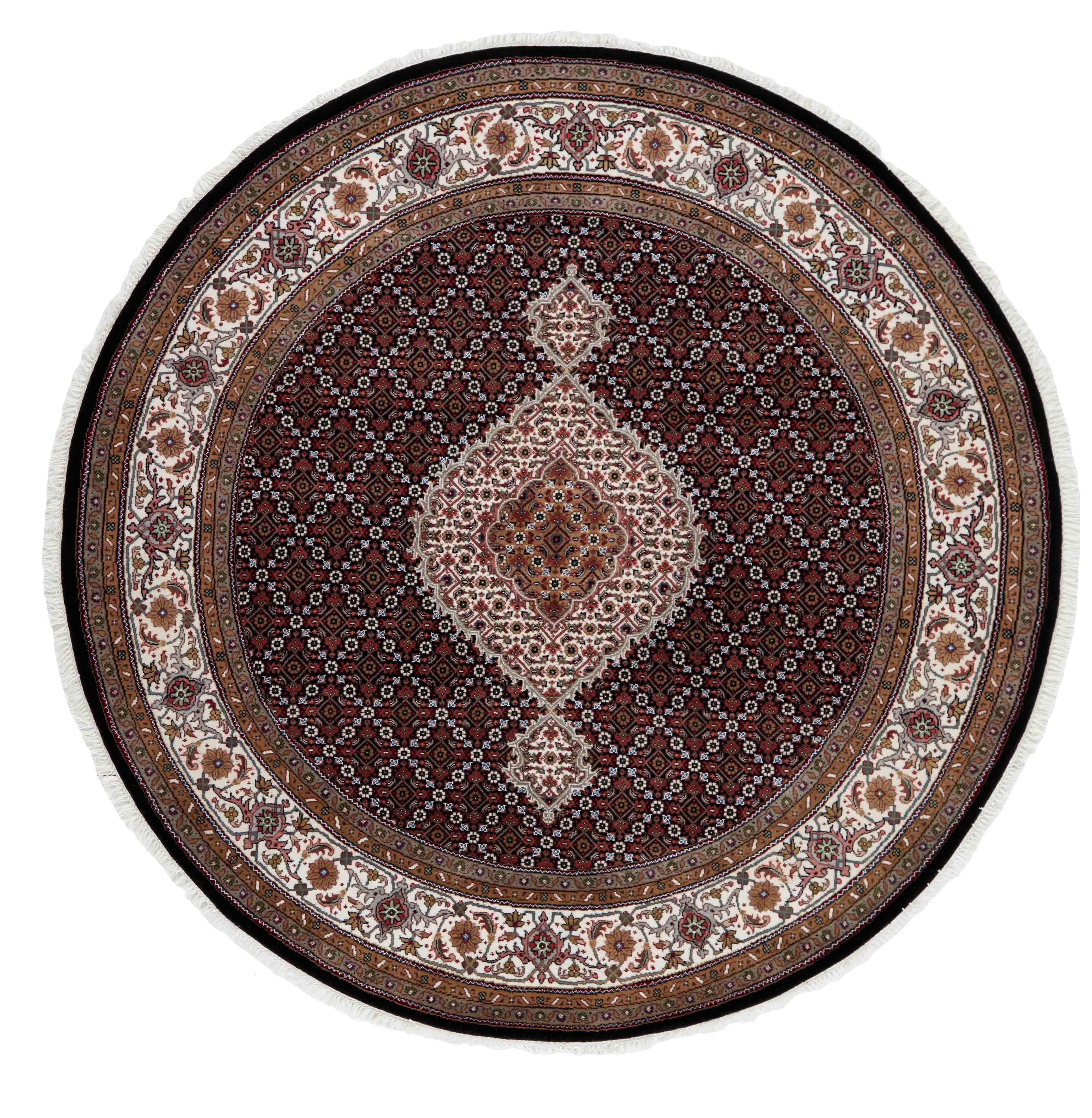 round Oriental rug with traditional geometric and floral design in red, beige and black
