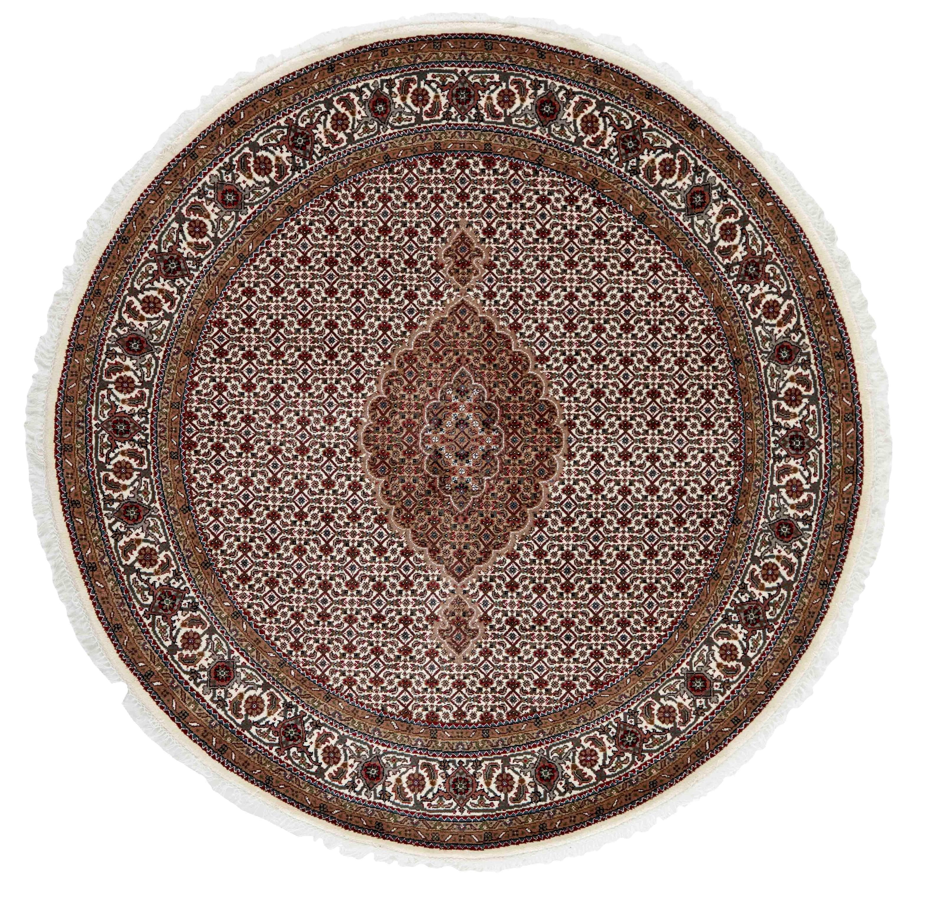 round Oriental rug with traditional geometric and floral design in red, beige and black