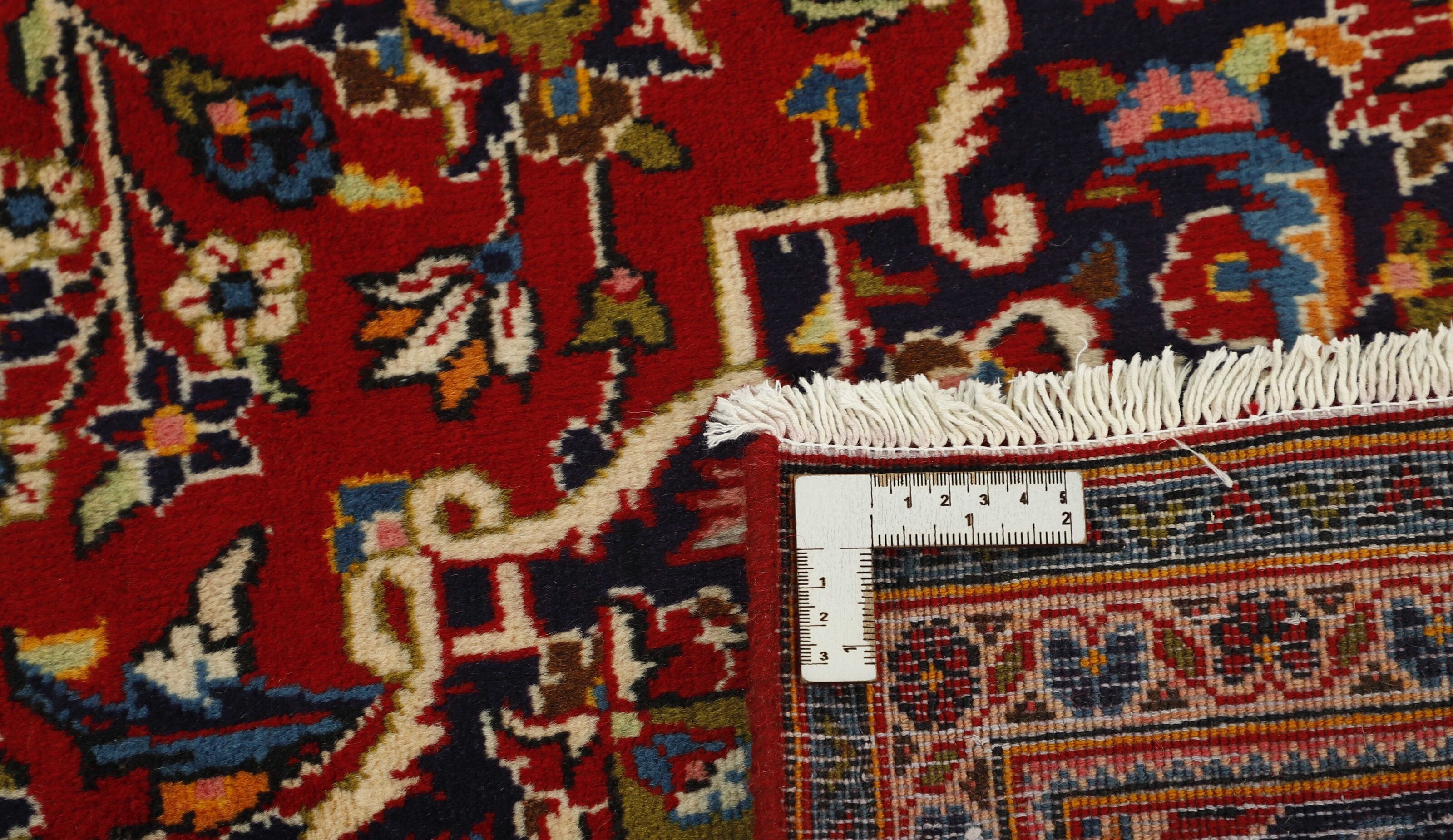 Traditional bordered Keshan rug with red background