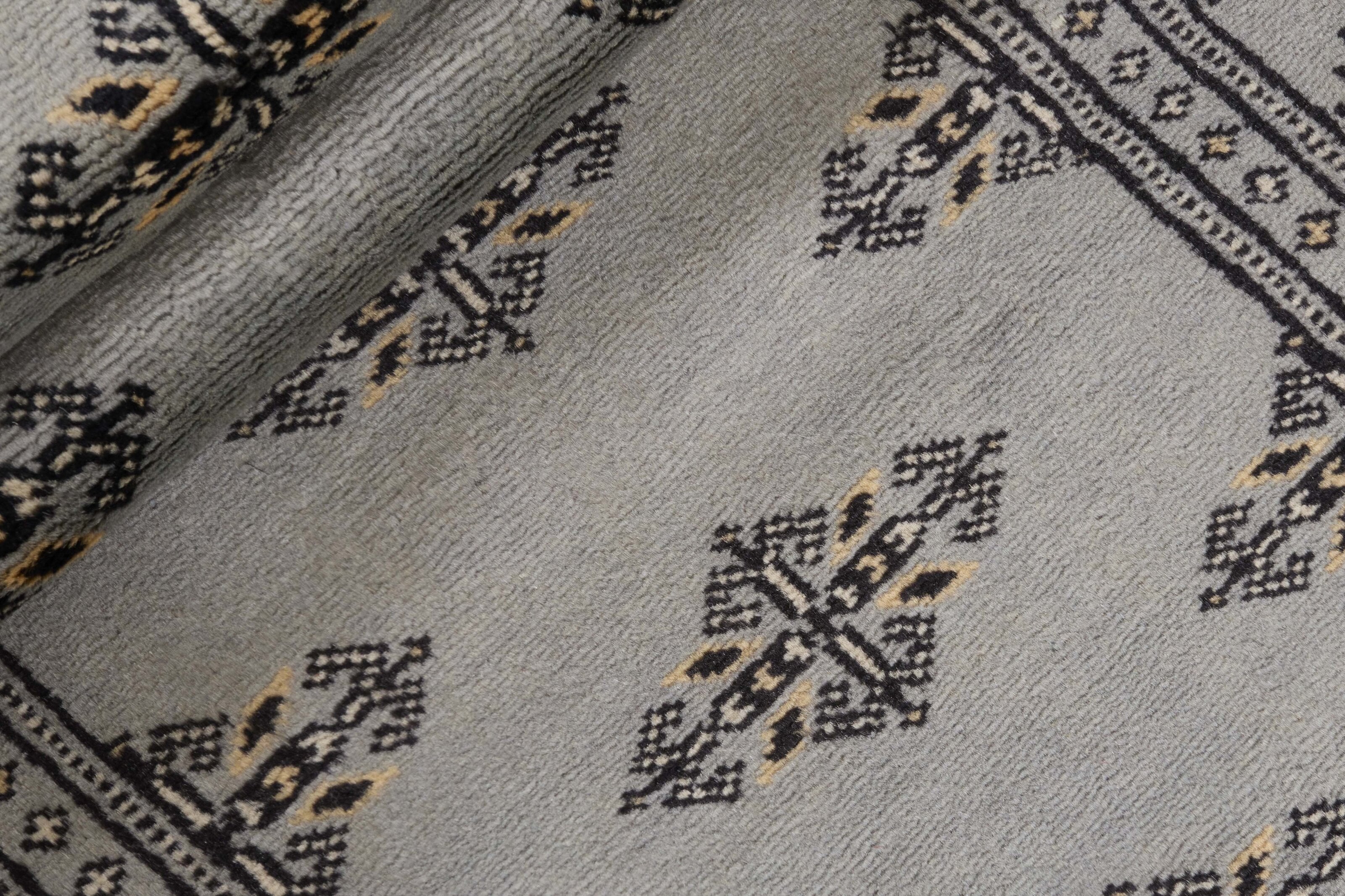 Grey Oriental runner with traditional bordered pattern