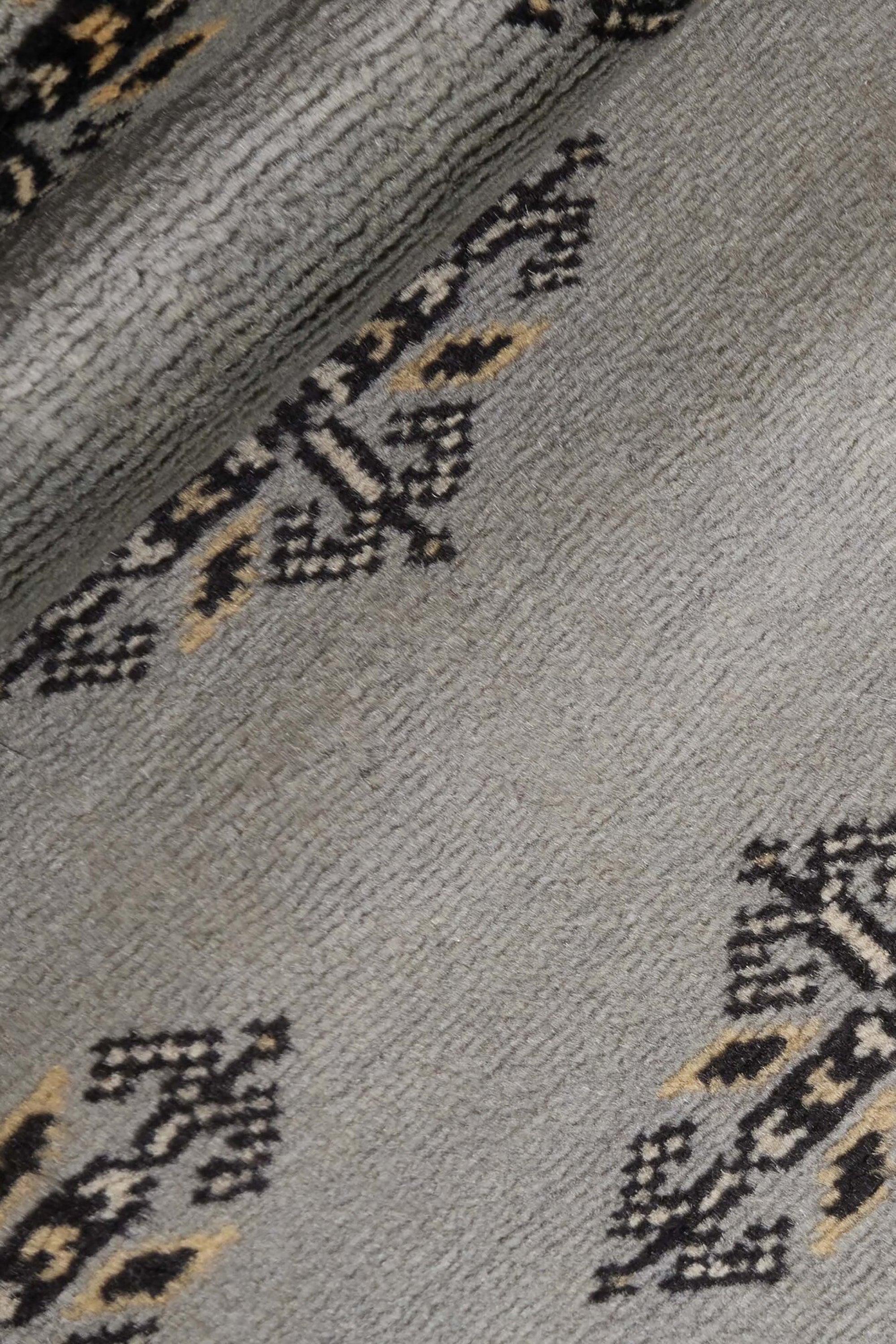 Grey Oriental runner with traditional bordered pattern