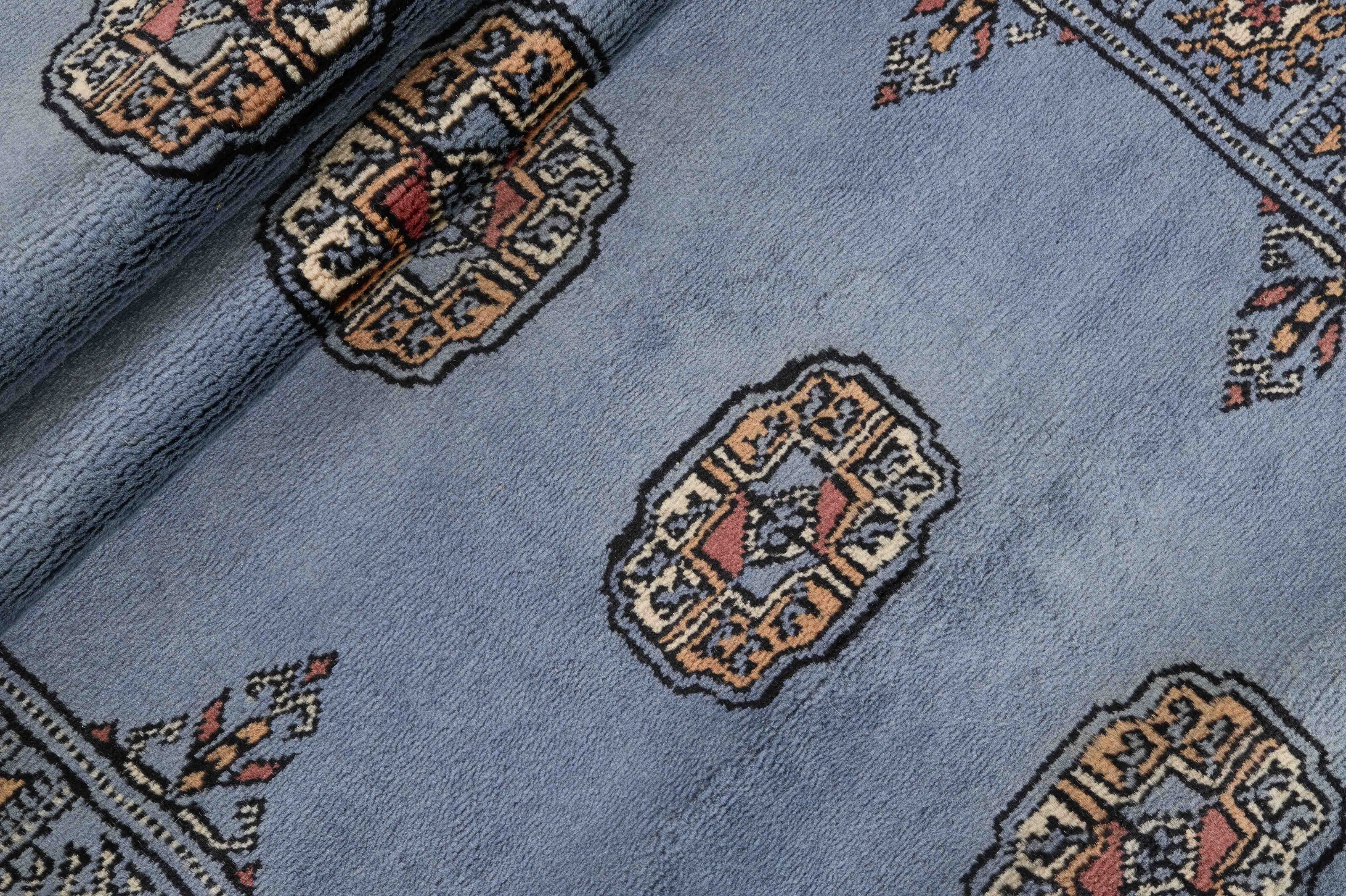 Blue Oriental runner with traditional bordered pattern