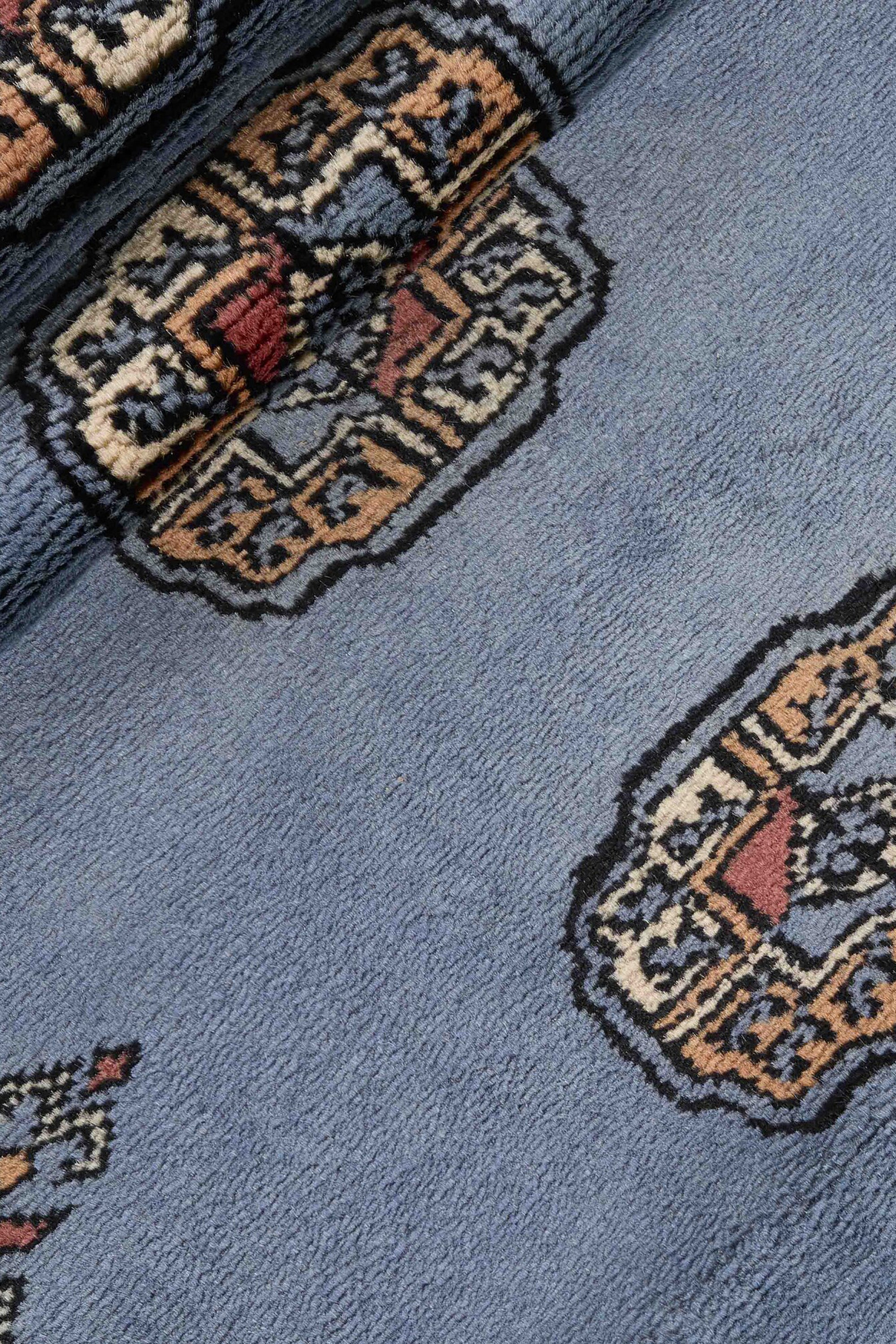 Blue Oriental runner with traditional bordered pattern