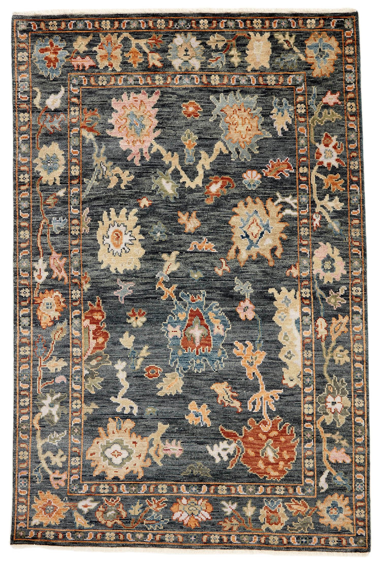 authentic Oriental rug with traditional motifs in red, pink, blue, green, beige, brown and black