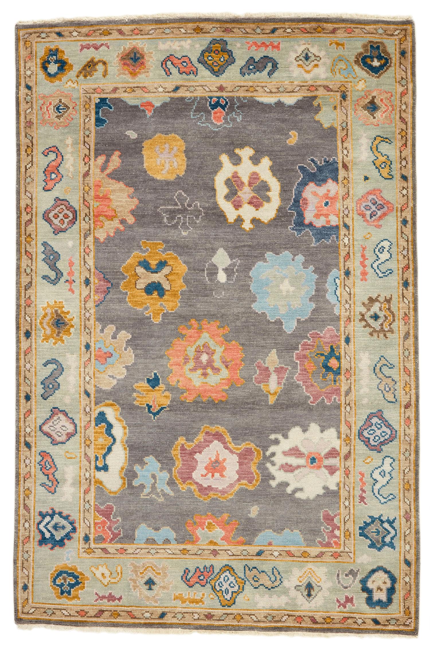 authentic Oriental rug with traditional motifs in red, pink, orange, yellow, blue, sky, green, beige, brown and grey