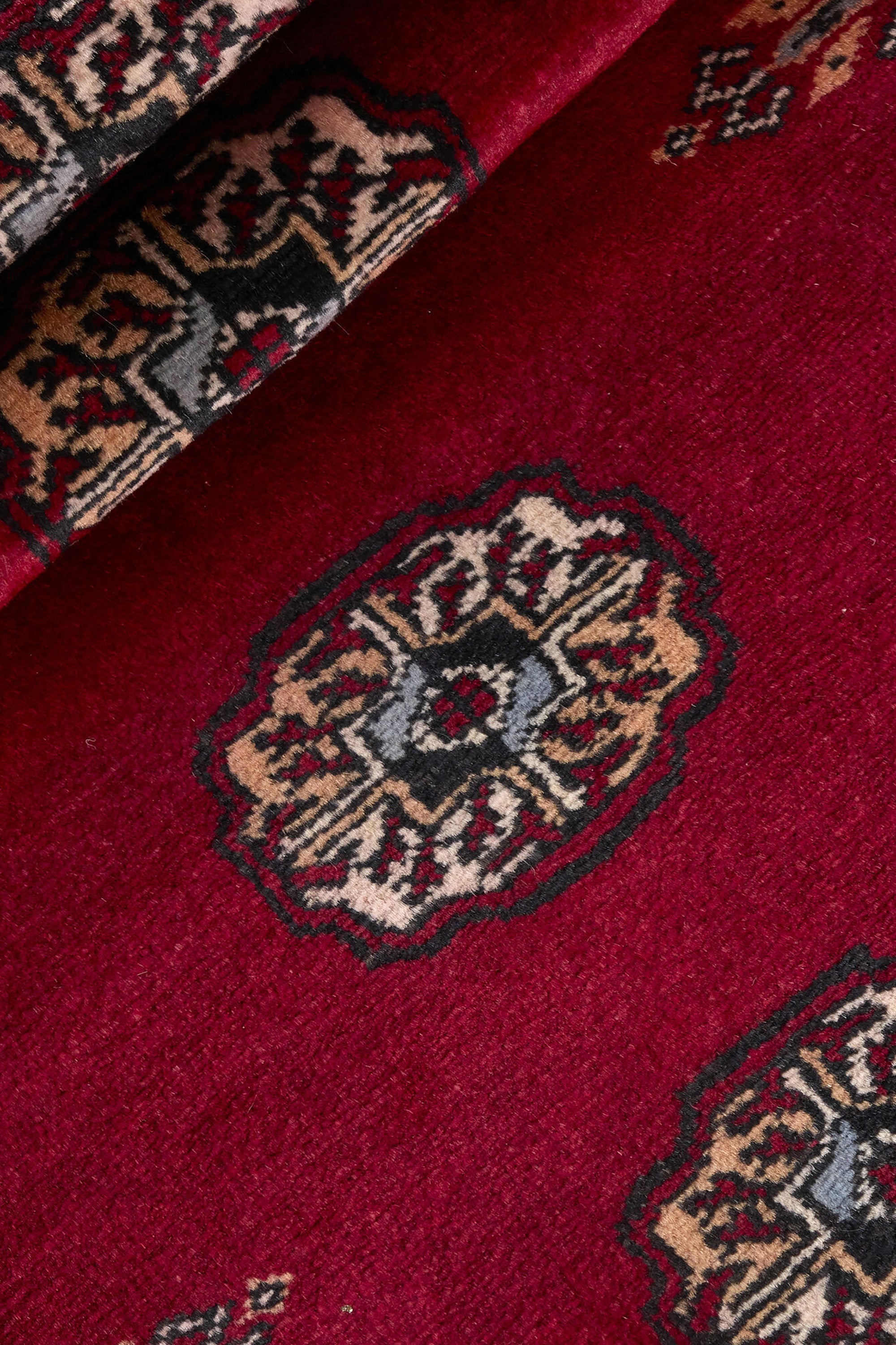 Red Oriental runner with traditional bordered pattern