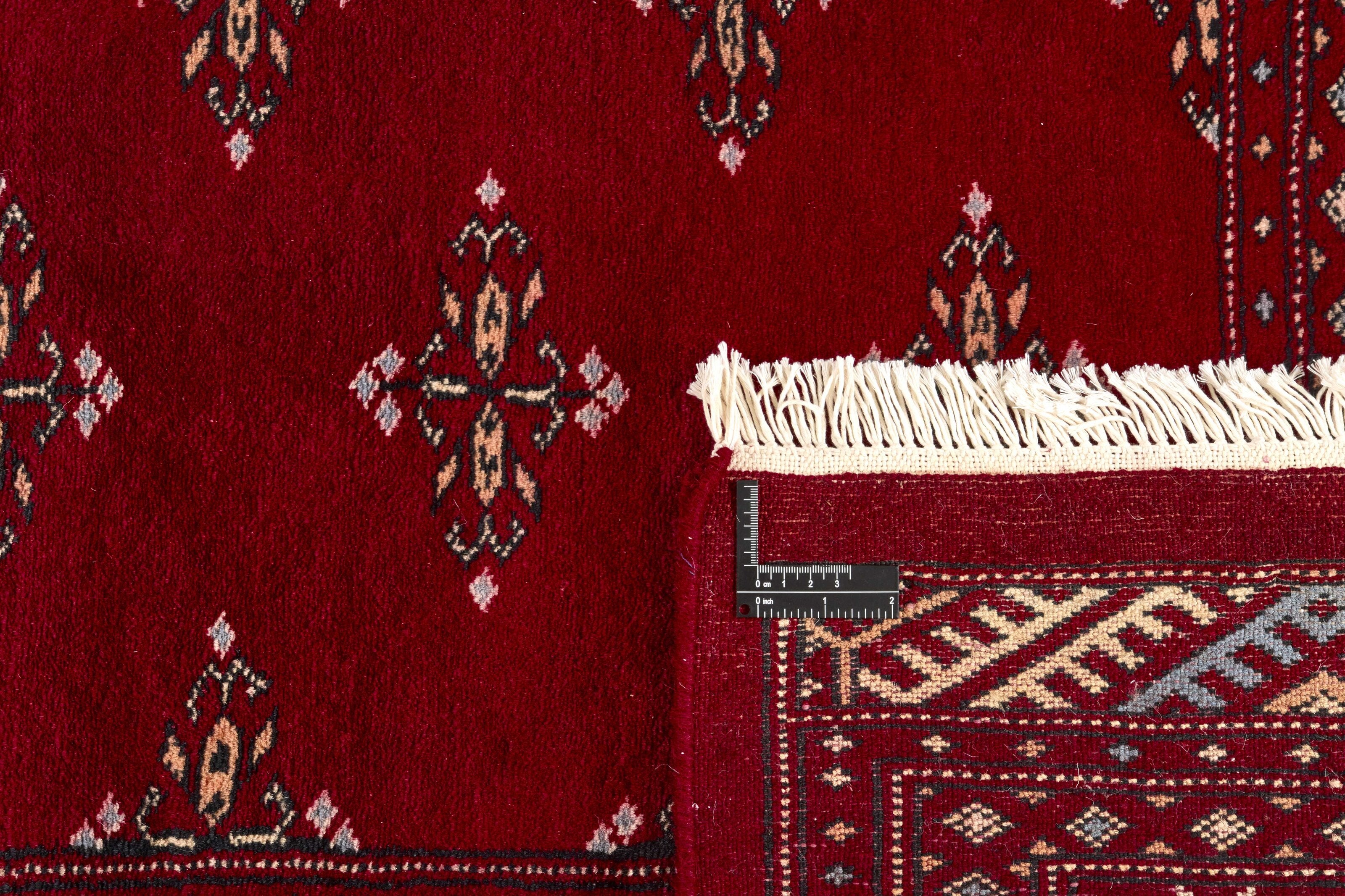 Red Oriental rug with traditional bordered pattern