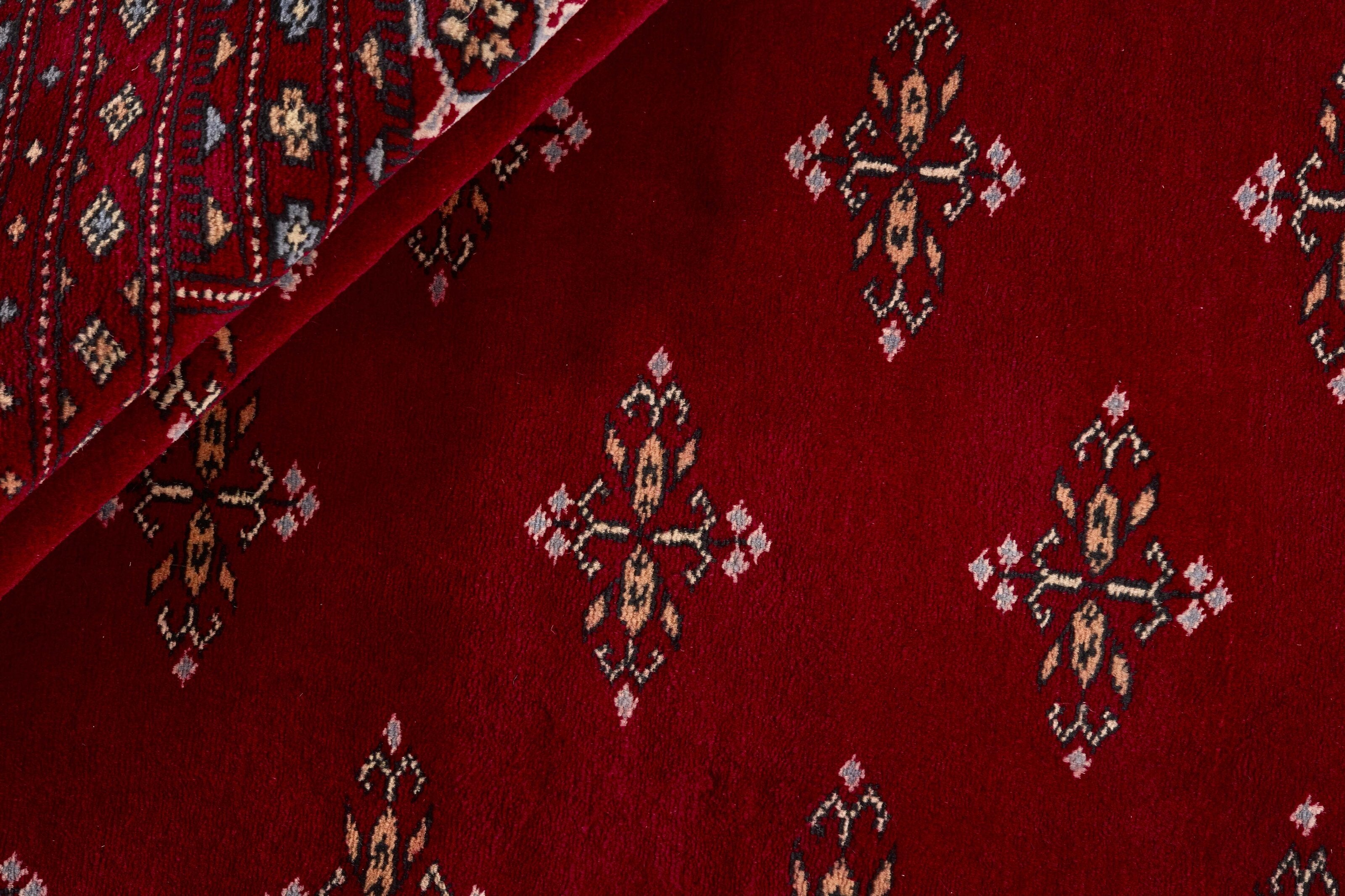 Red Oriental rug with traditional bordered pattern