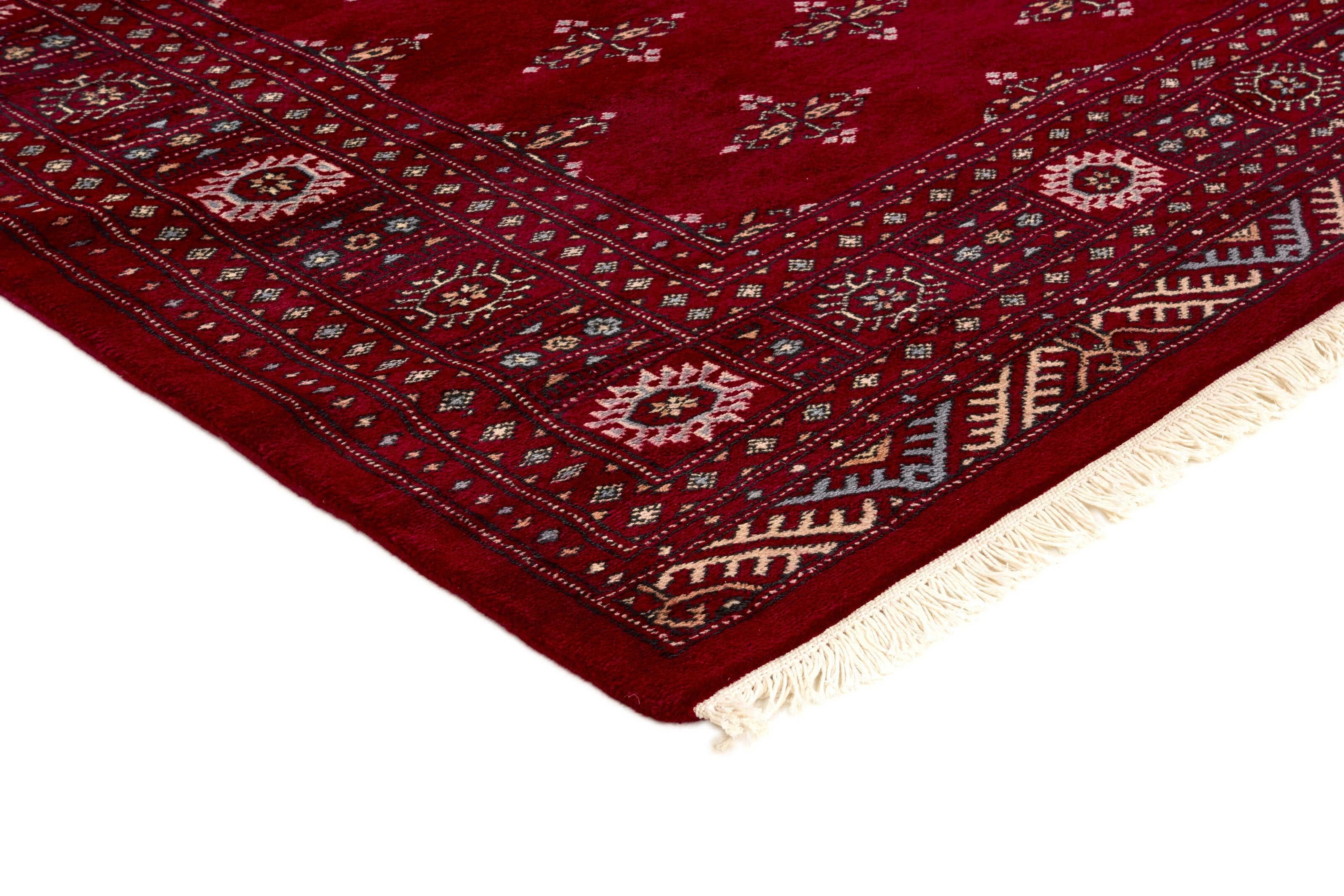 Red Oriental rug with traditional bordered pattern