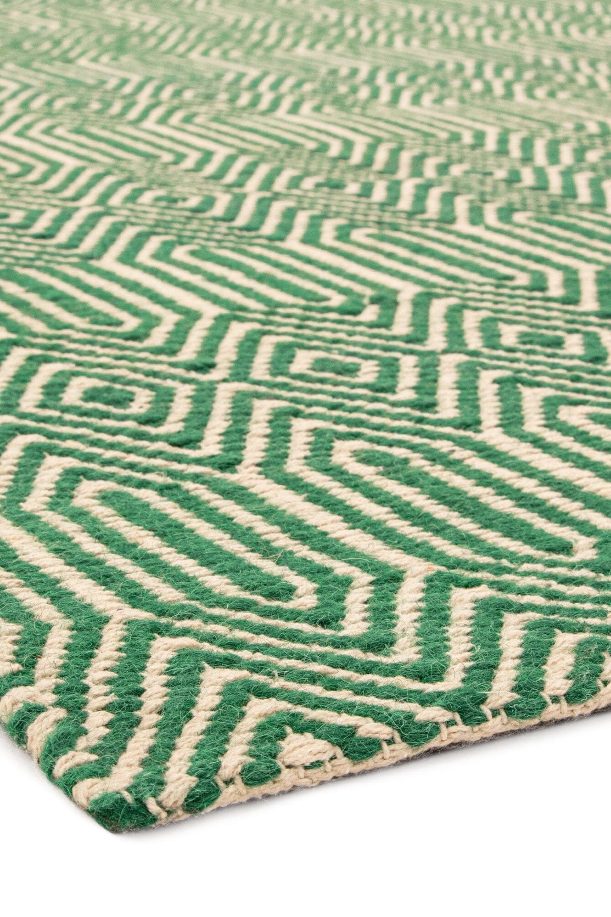 green and white runner with a geometric aztec design