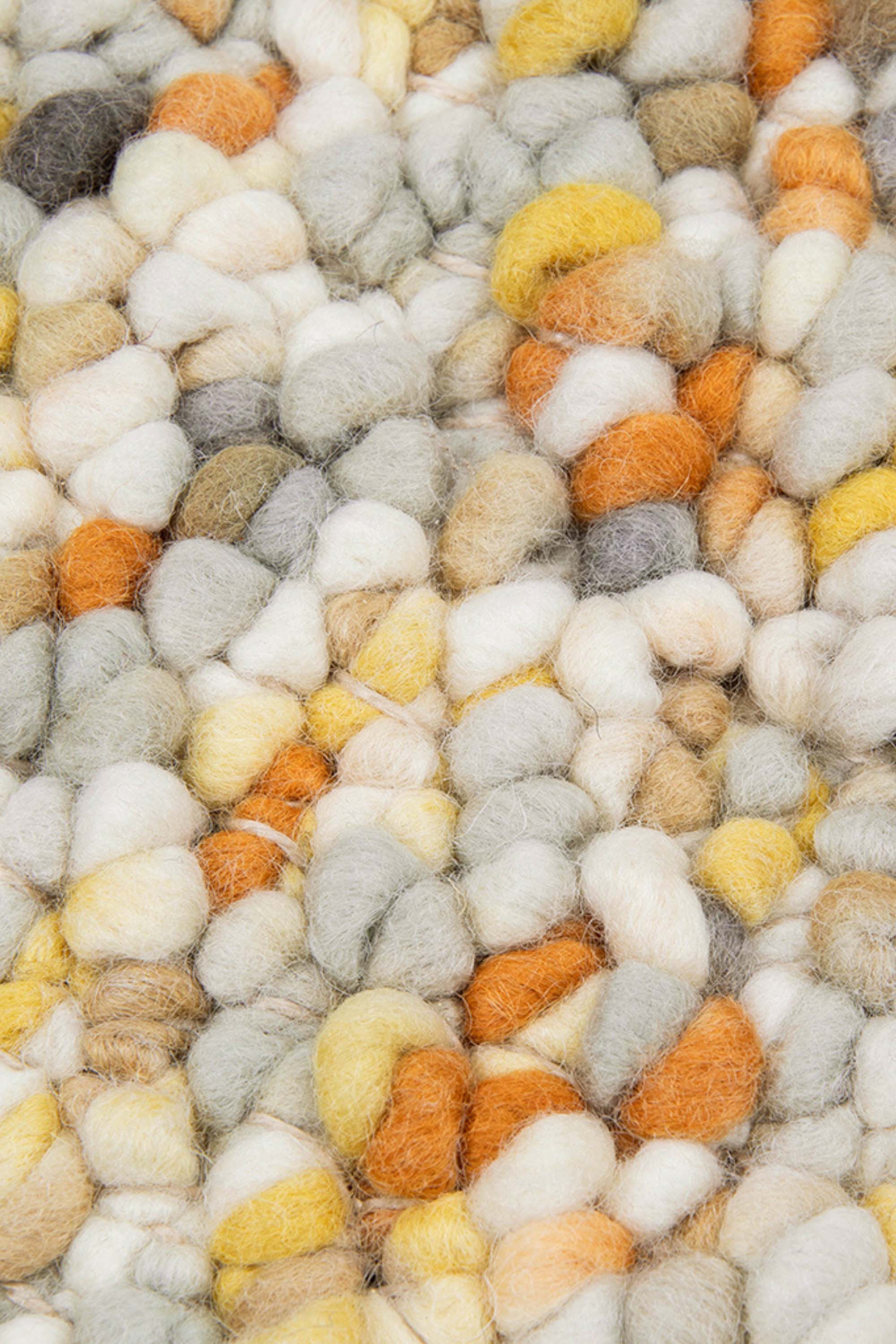 cream, orange and yellow textured area rug