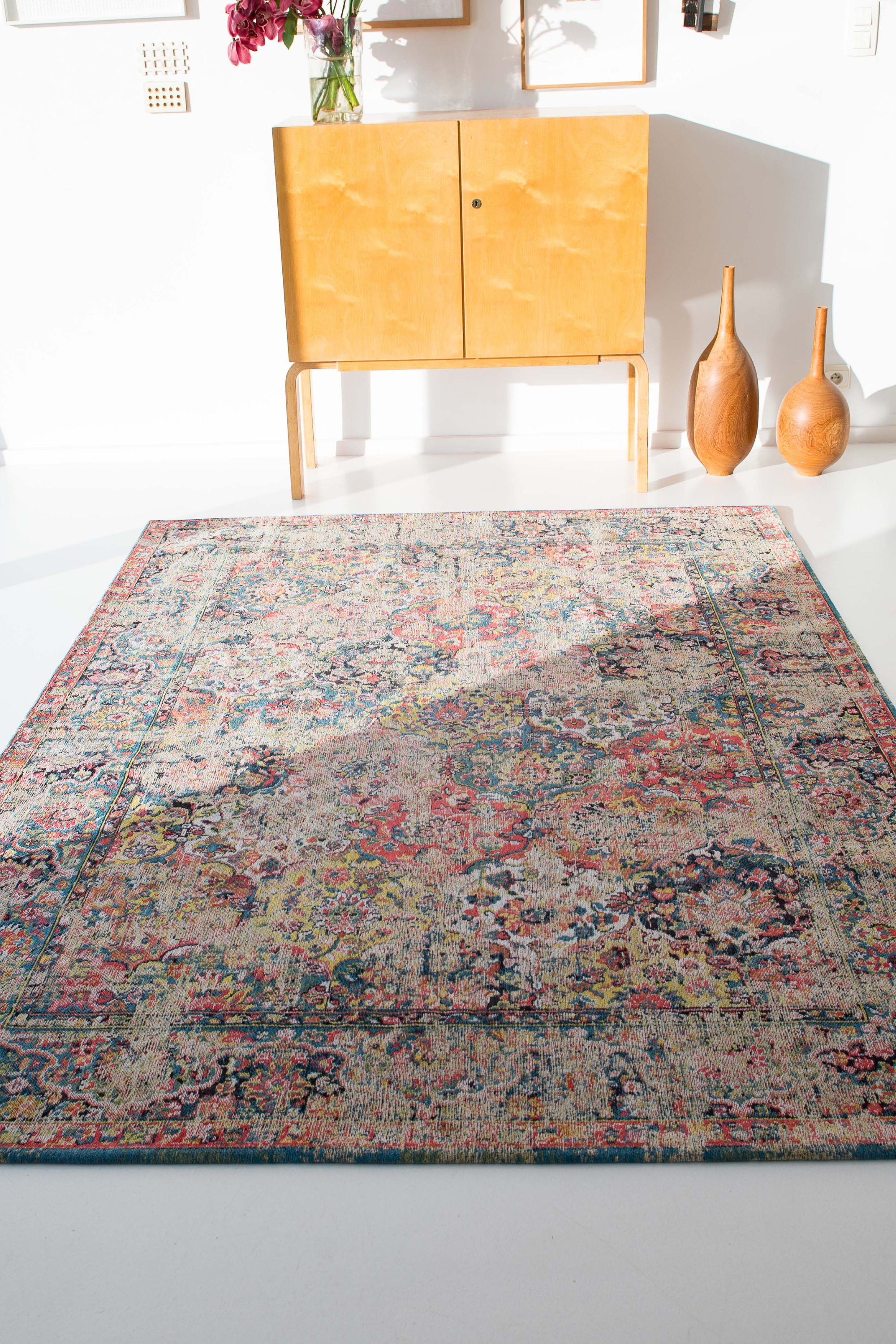 Flatweave rug with faded persian design in blue, red and yellow