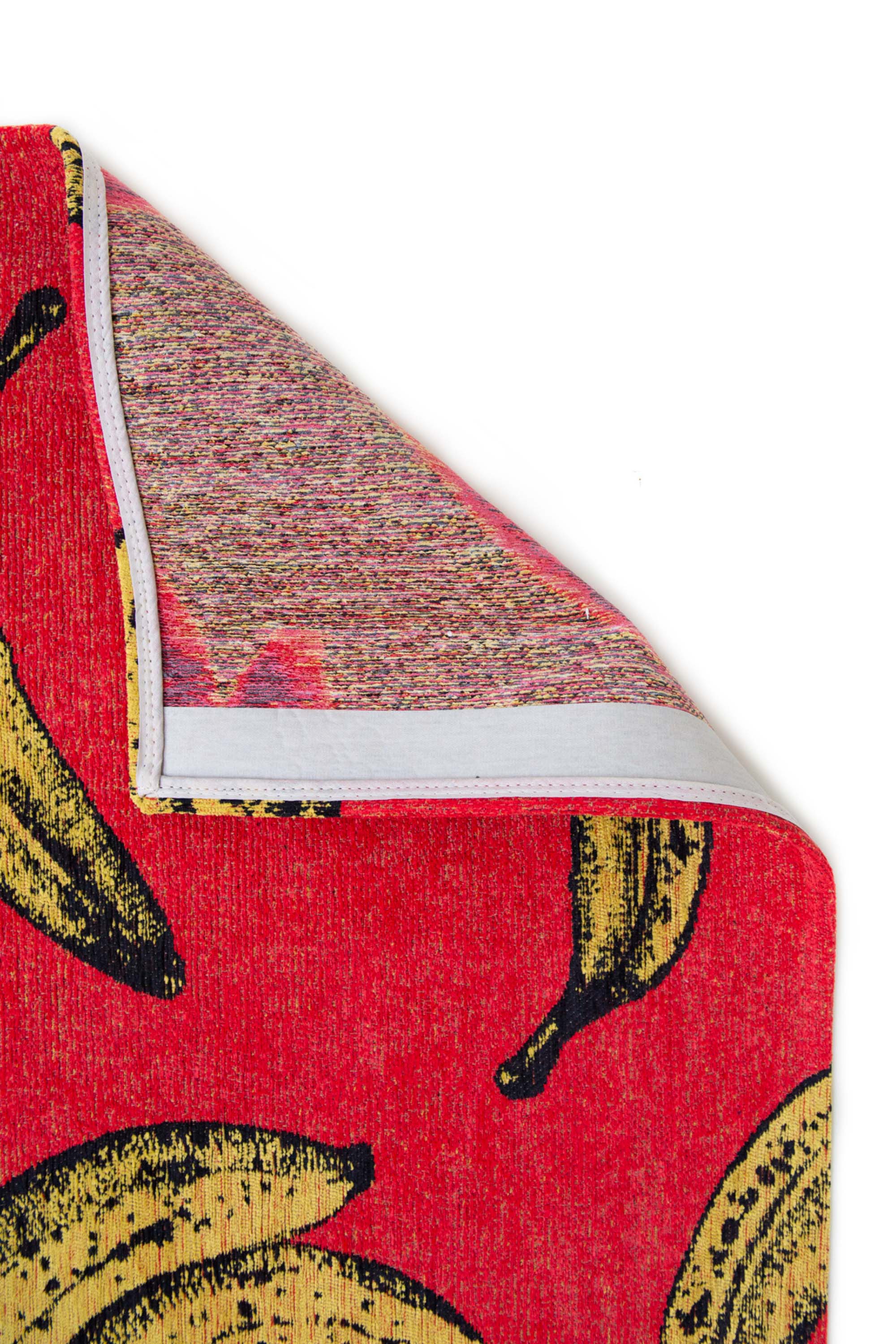 Modern red rug with repeated banana motif