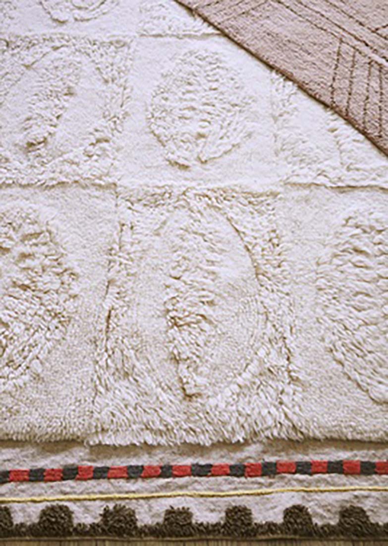 cream area rug with embossed shell design
