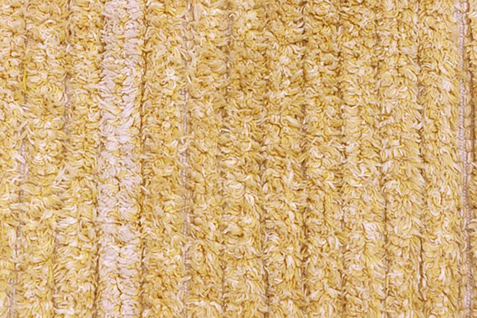 reversible textured rug in beige and yellow with soft gradient design
