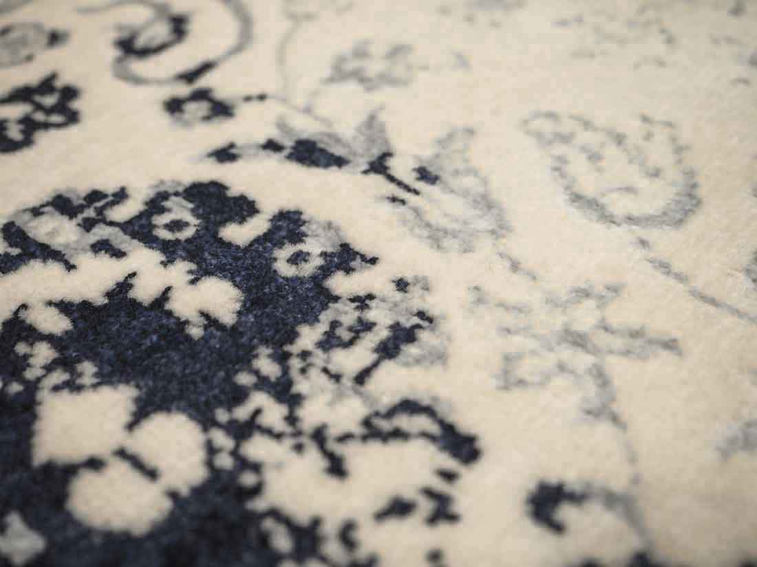 cream and blue oriental rug with a floral design