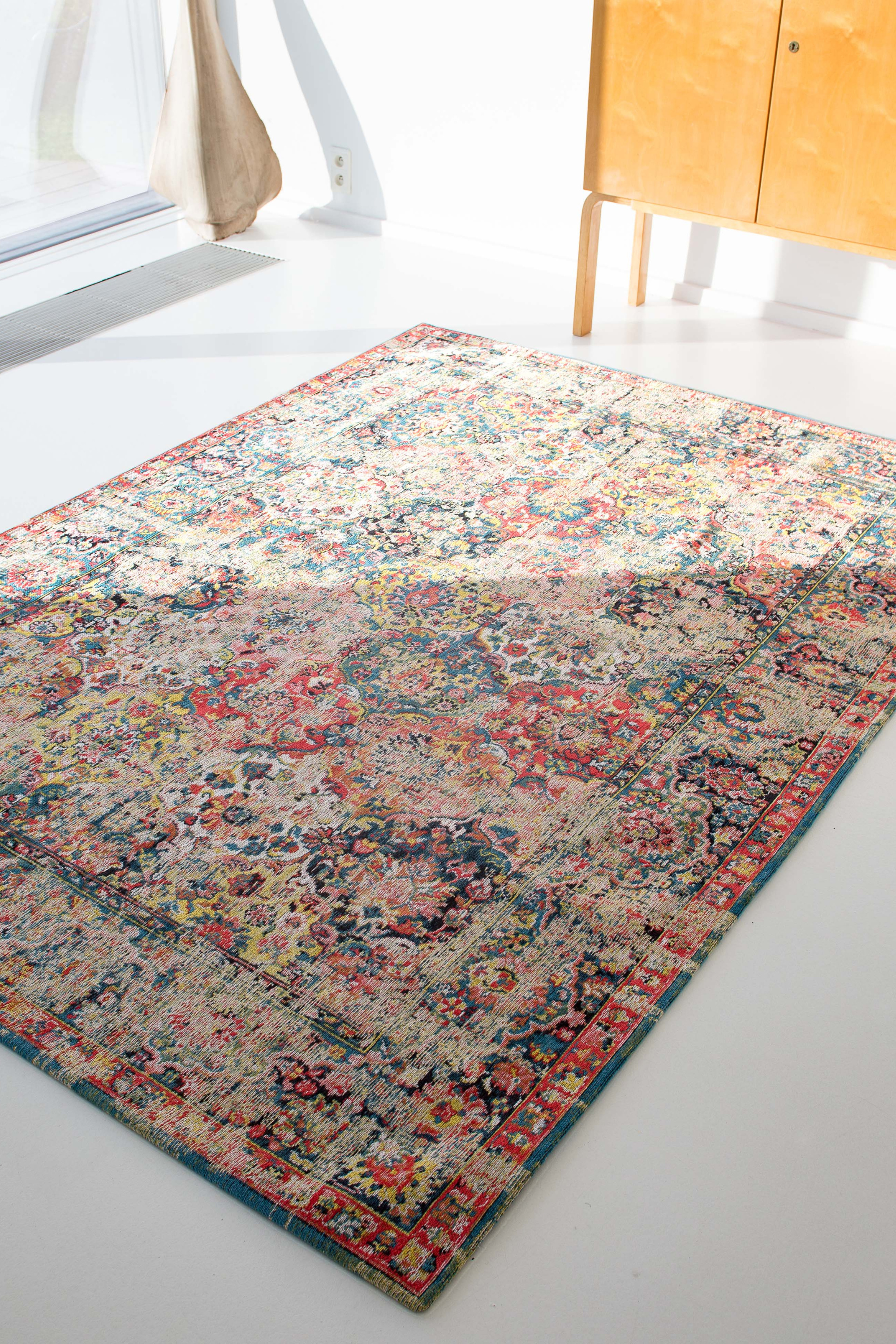 Flatweave rug with faded persian design in blue, red and yellow