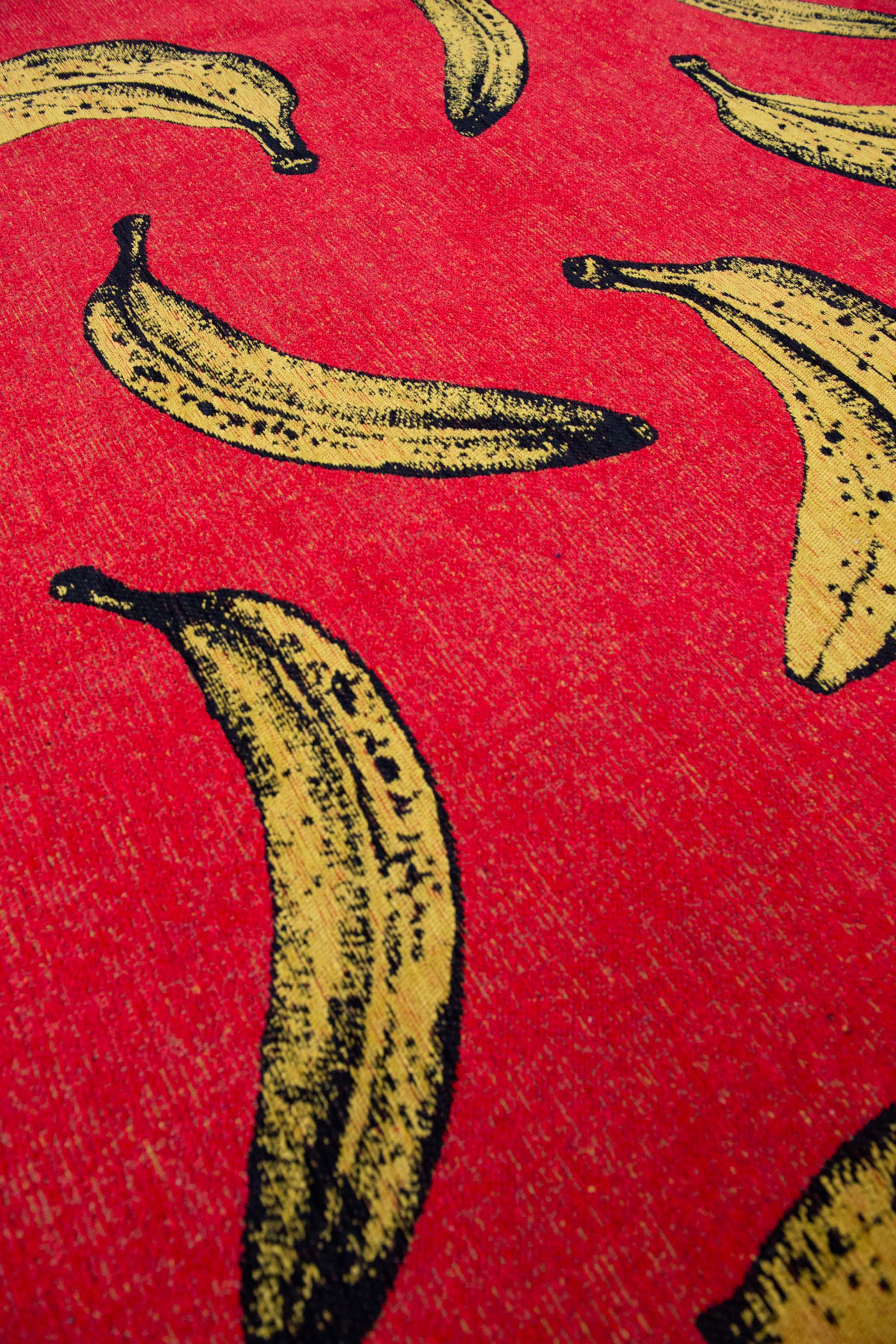 Modern red rug with repeated banana motif