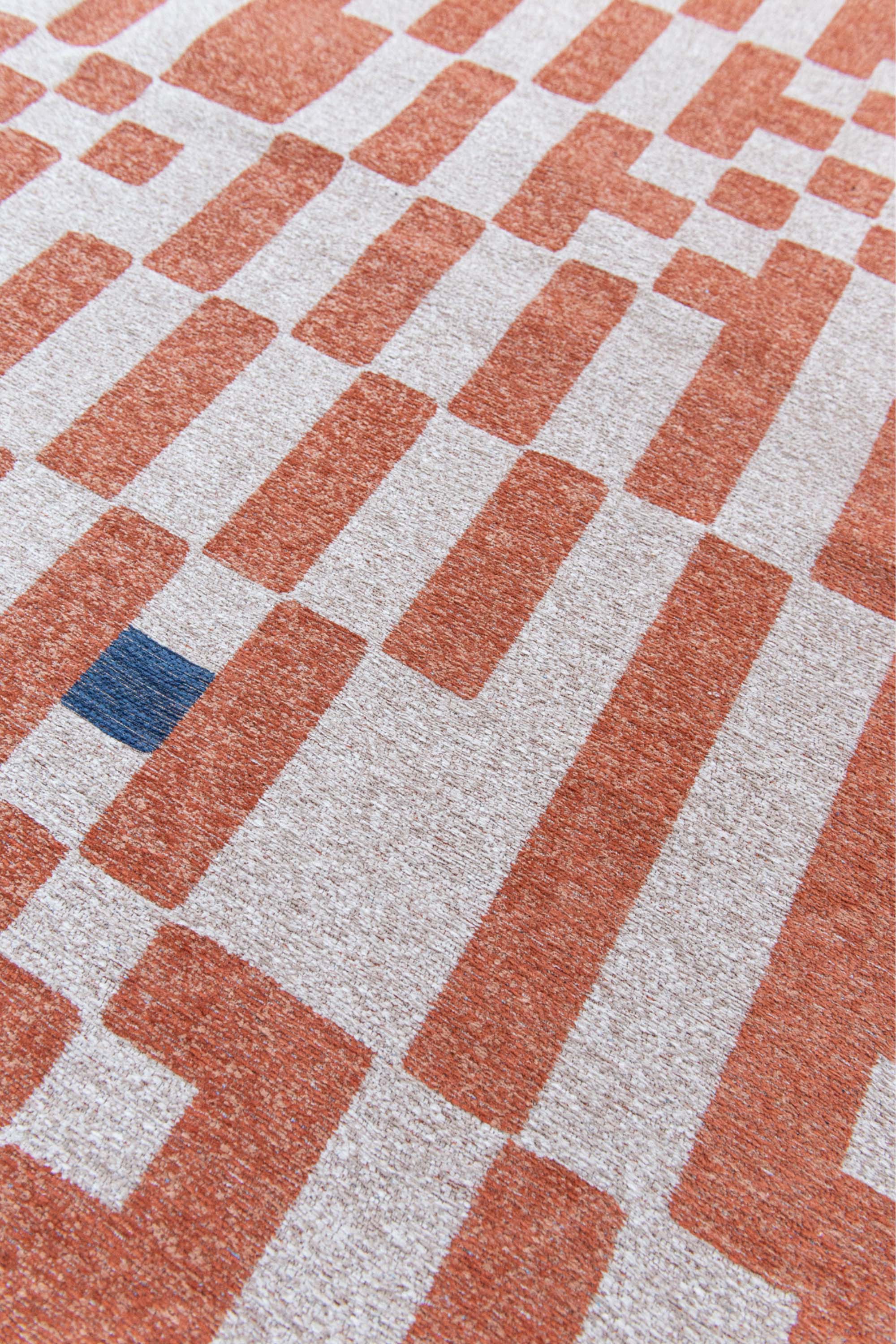 Abstract geometric rug with orange, blue, and white tones