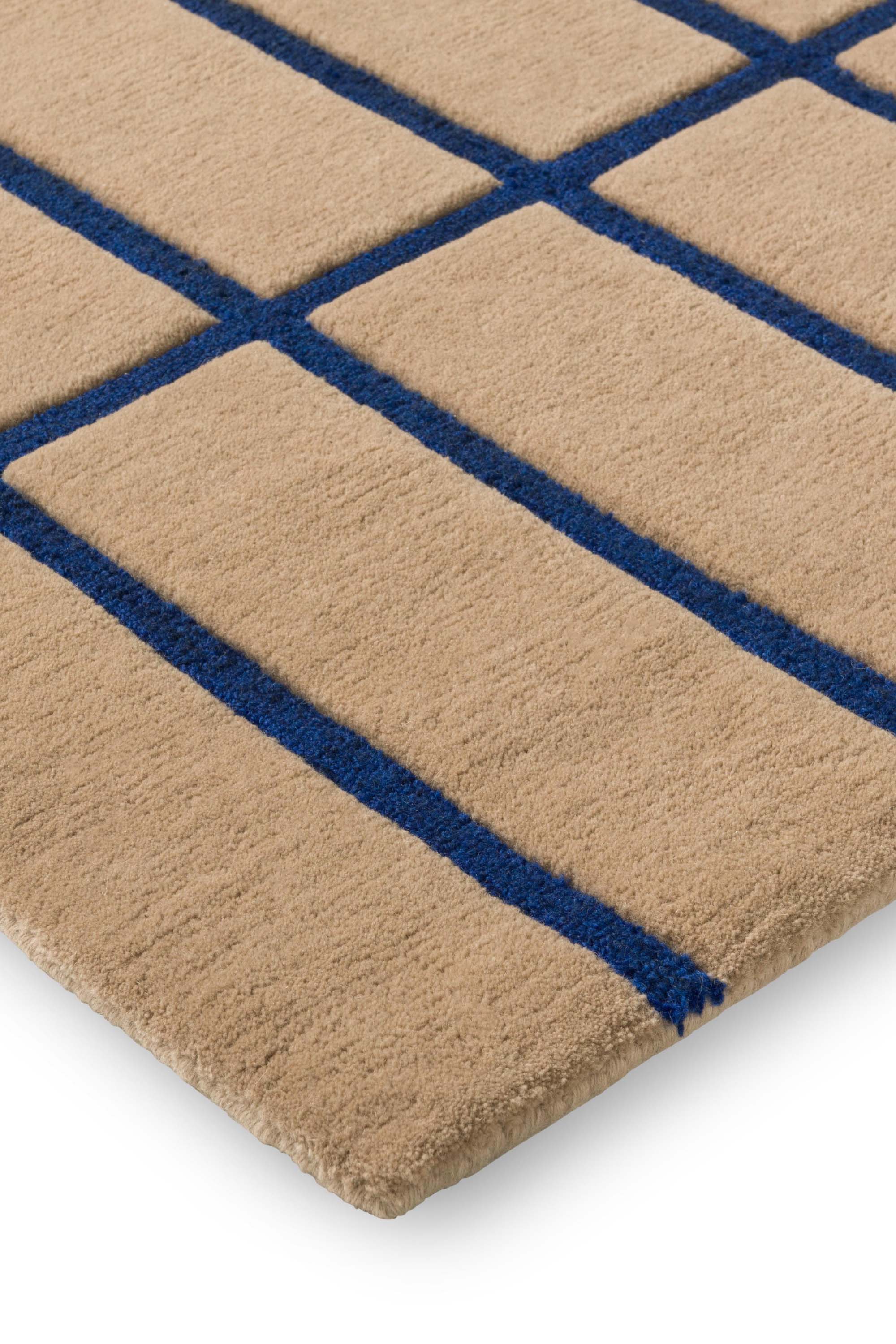 Geometric rug with blue grid pattern