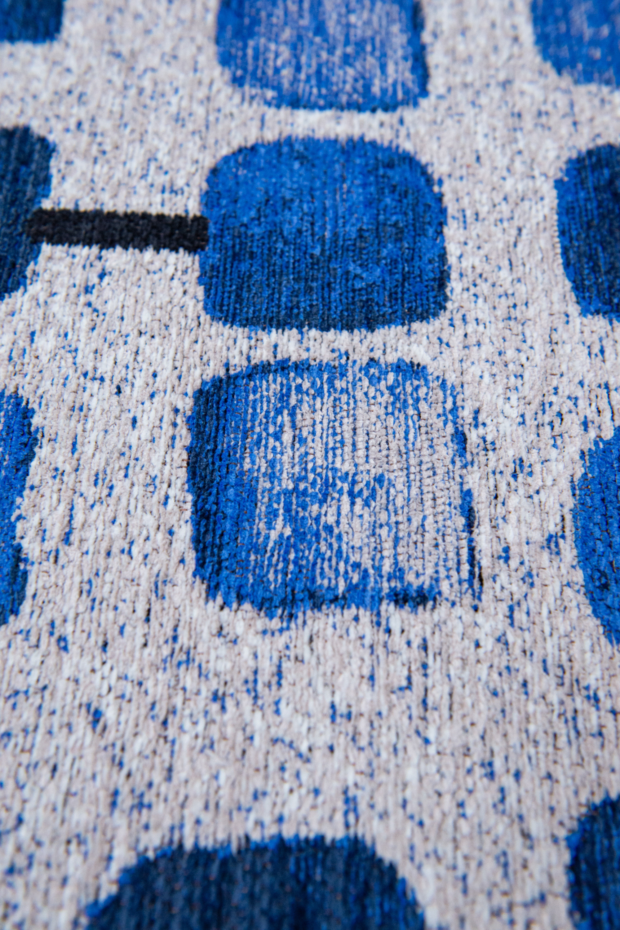 Modern blue rug with repeated peach motif pattern