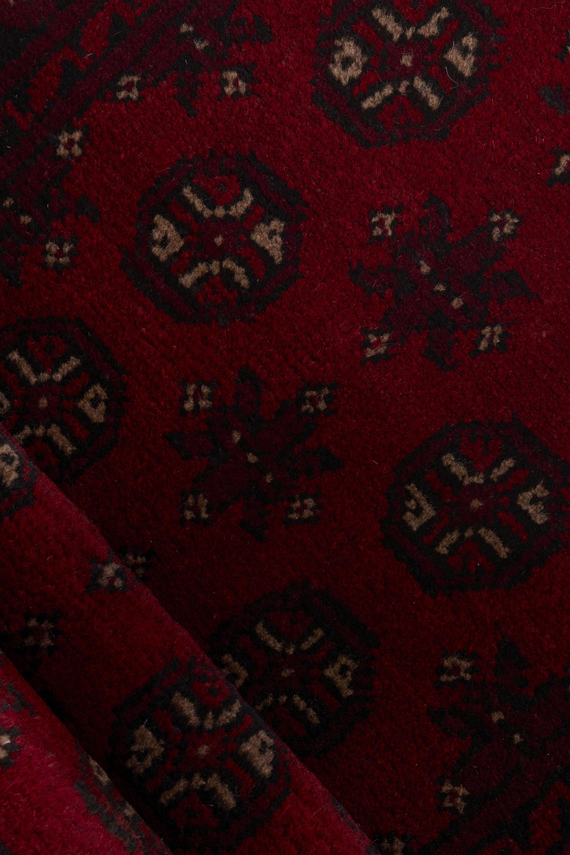 Red oriental wool runner with a traditional elephant's foot pattern