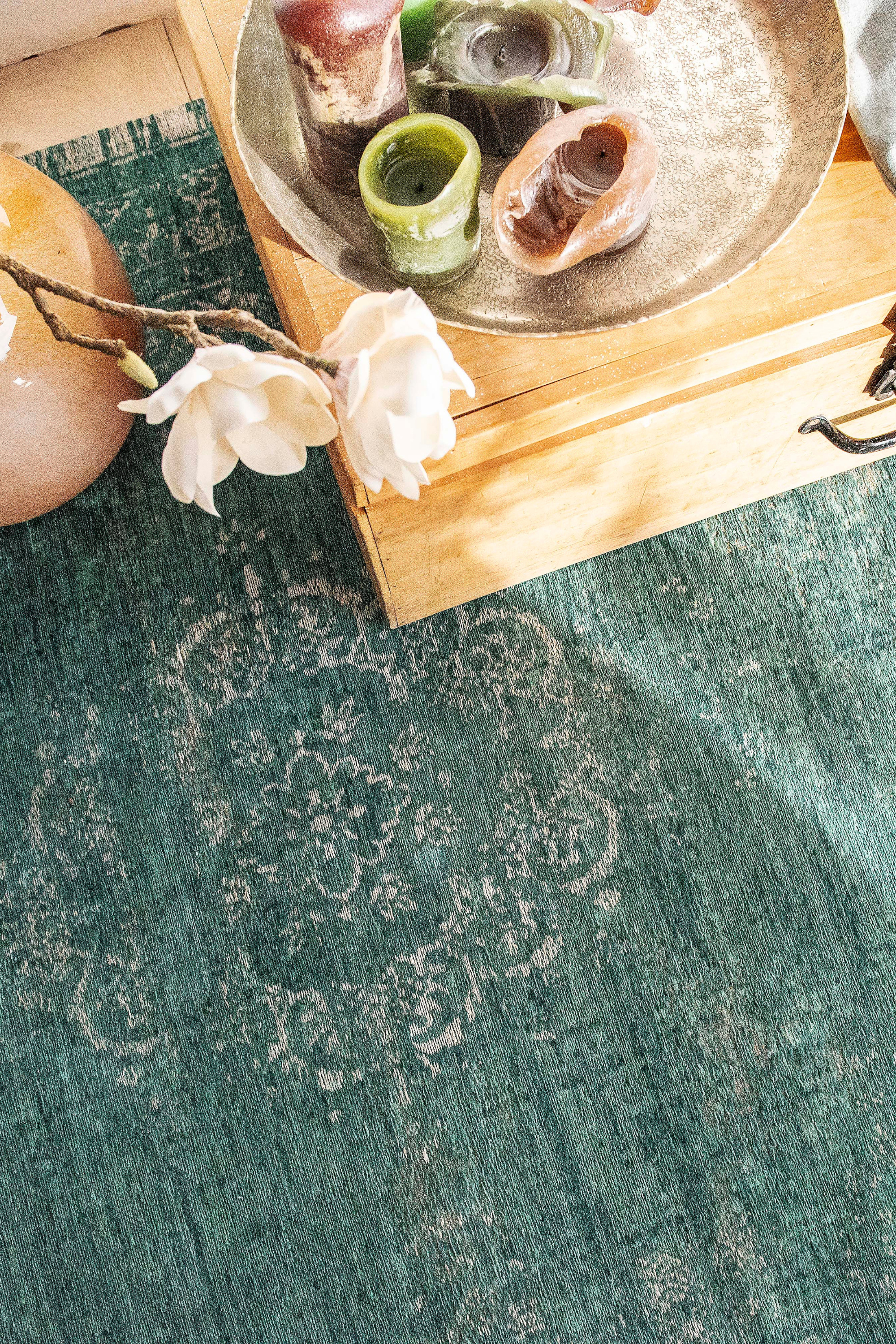 green flatweave rug with faded persian design