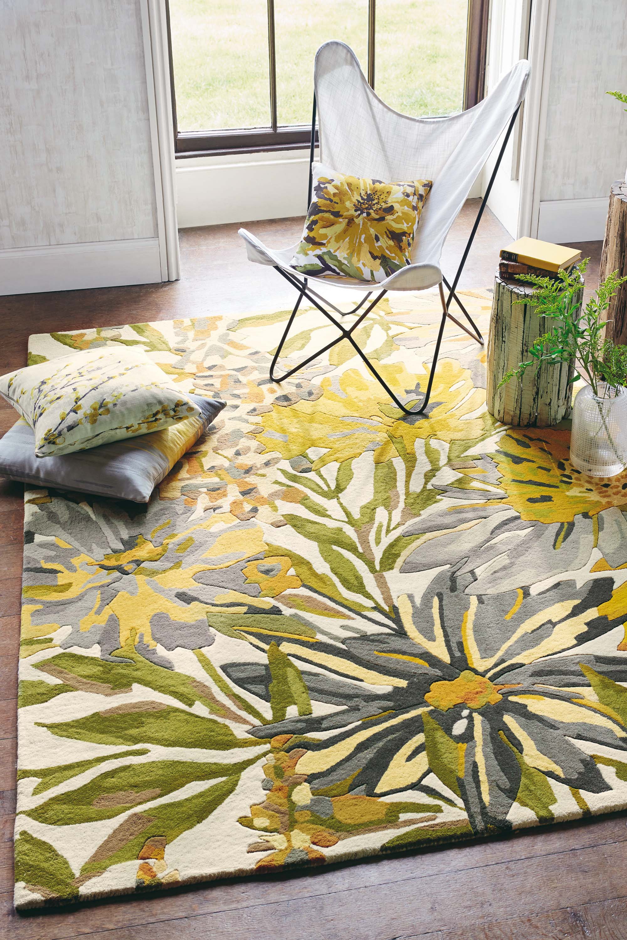 Rectangular white wool rug with yellow, green and brown leaves and flowers