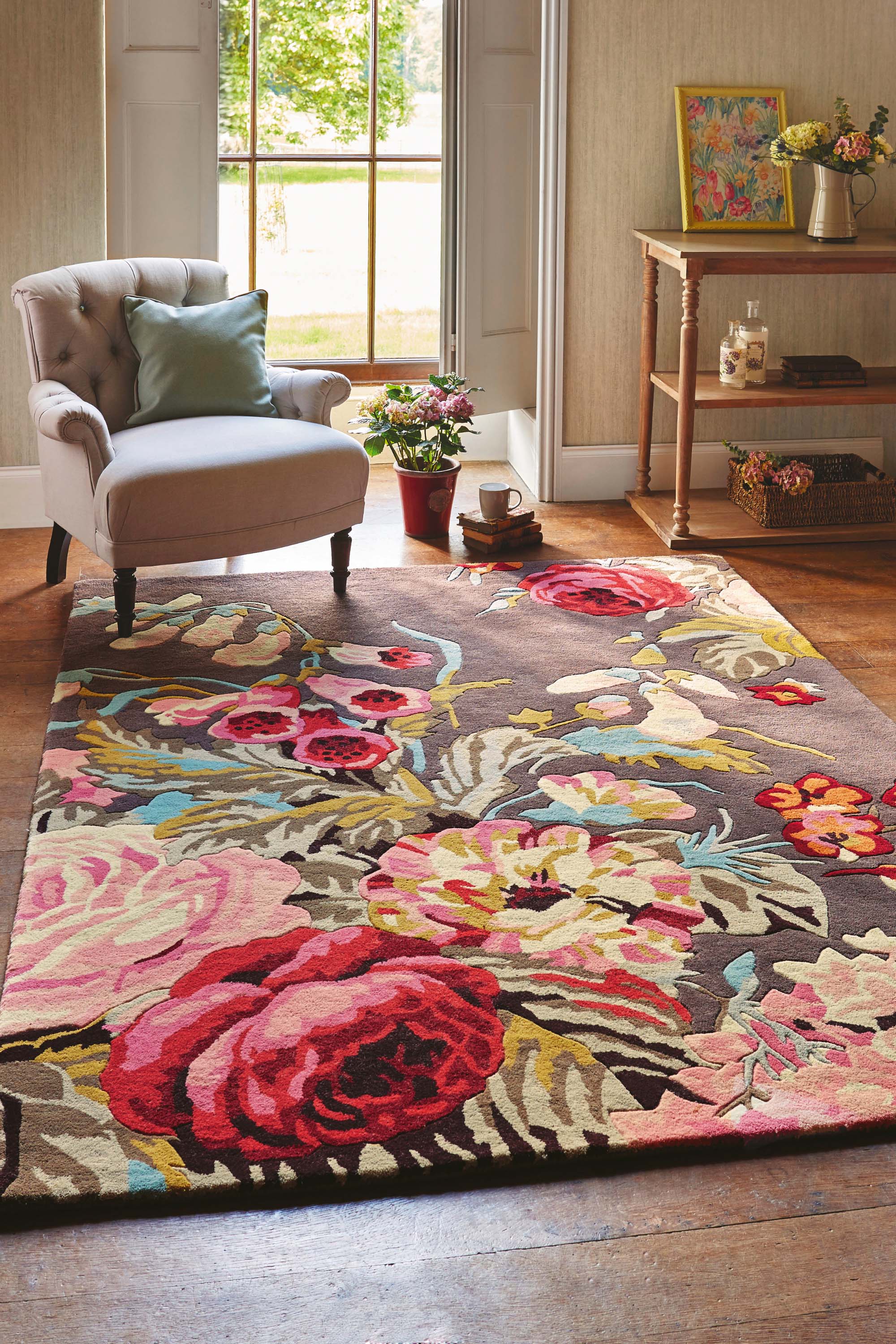Rectangular grey rug with floral rose and leaf illustrations in grey, pink, green and blue