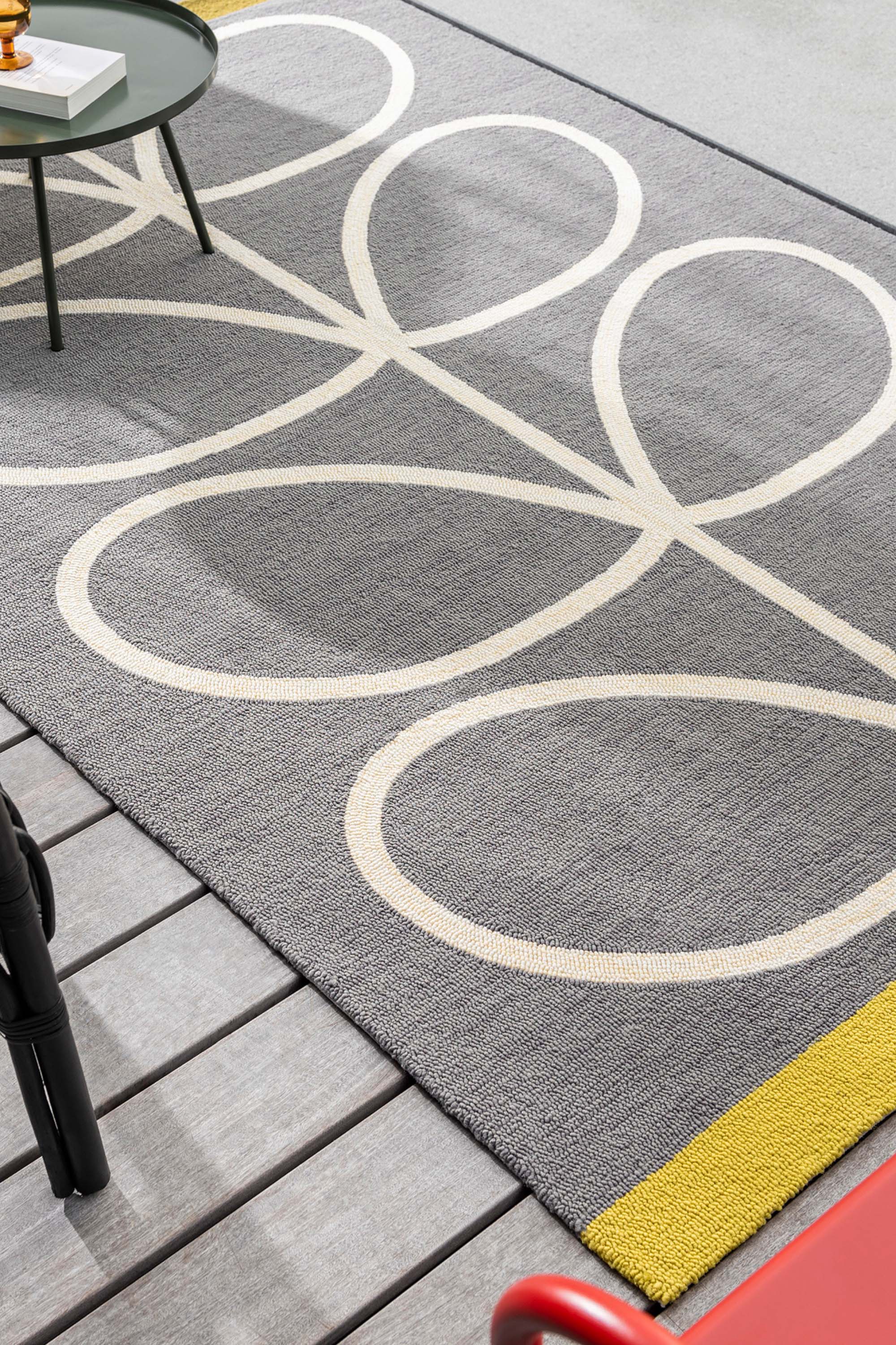 grey indoor/outdoor rug with oversized floral print
