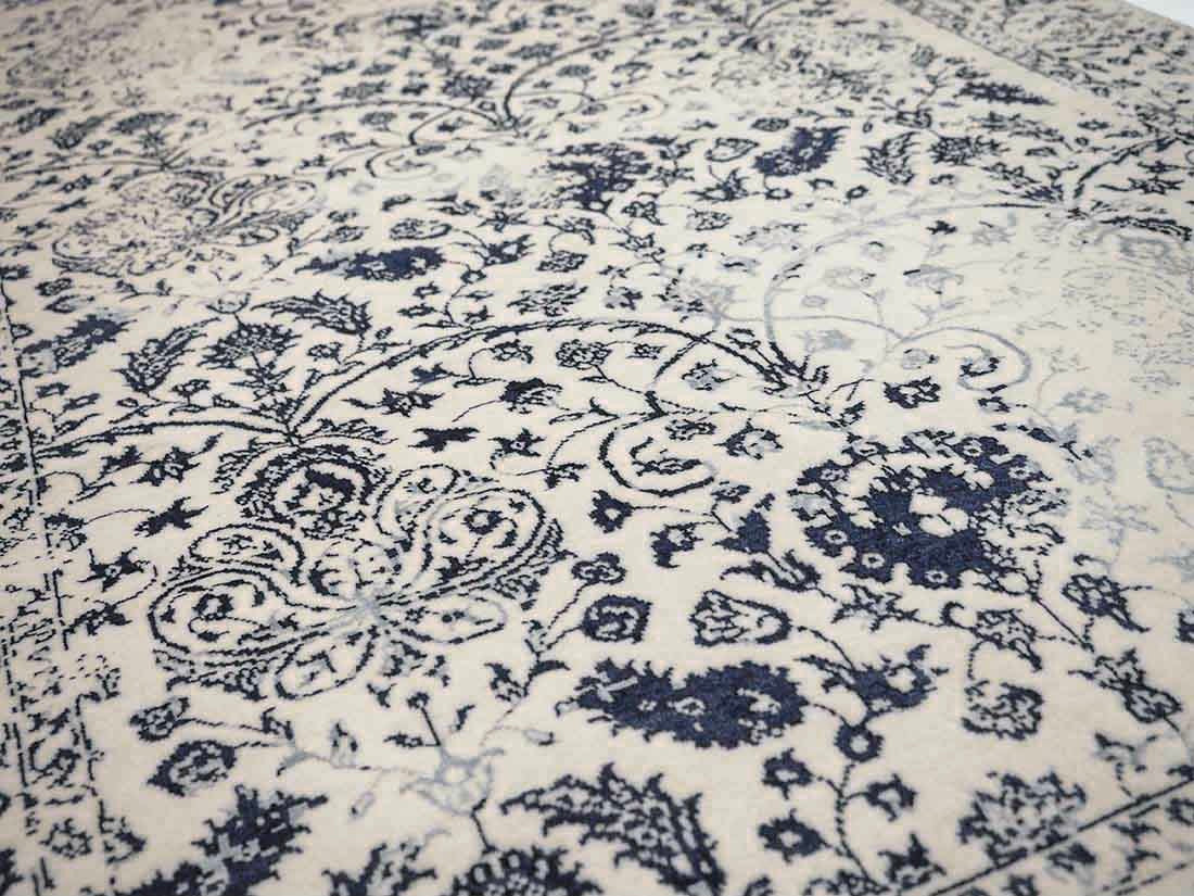 cream and blue oriental rug with a floral design