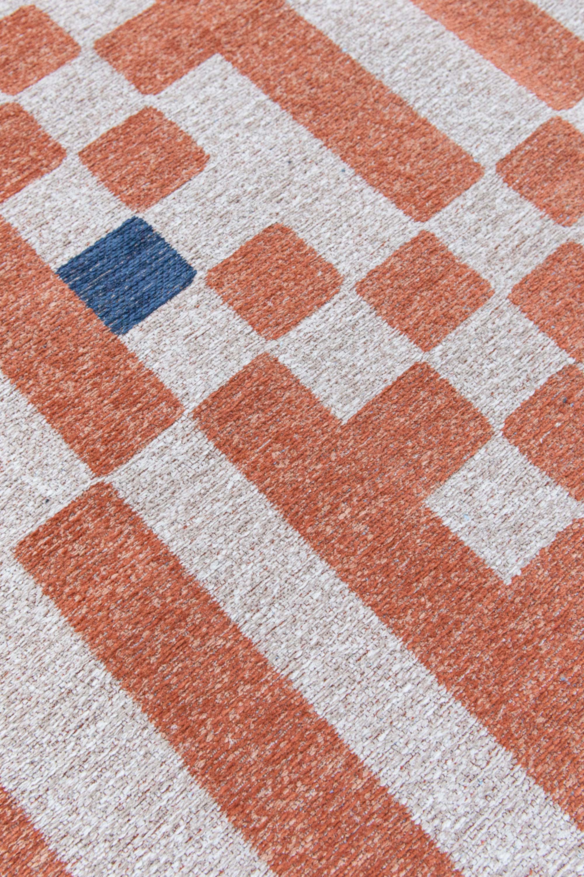 Abstract geometric rug with orange, blue, and white tones