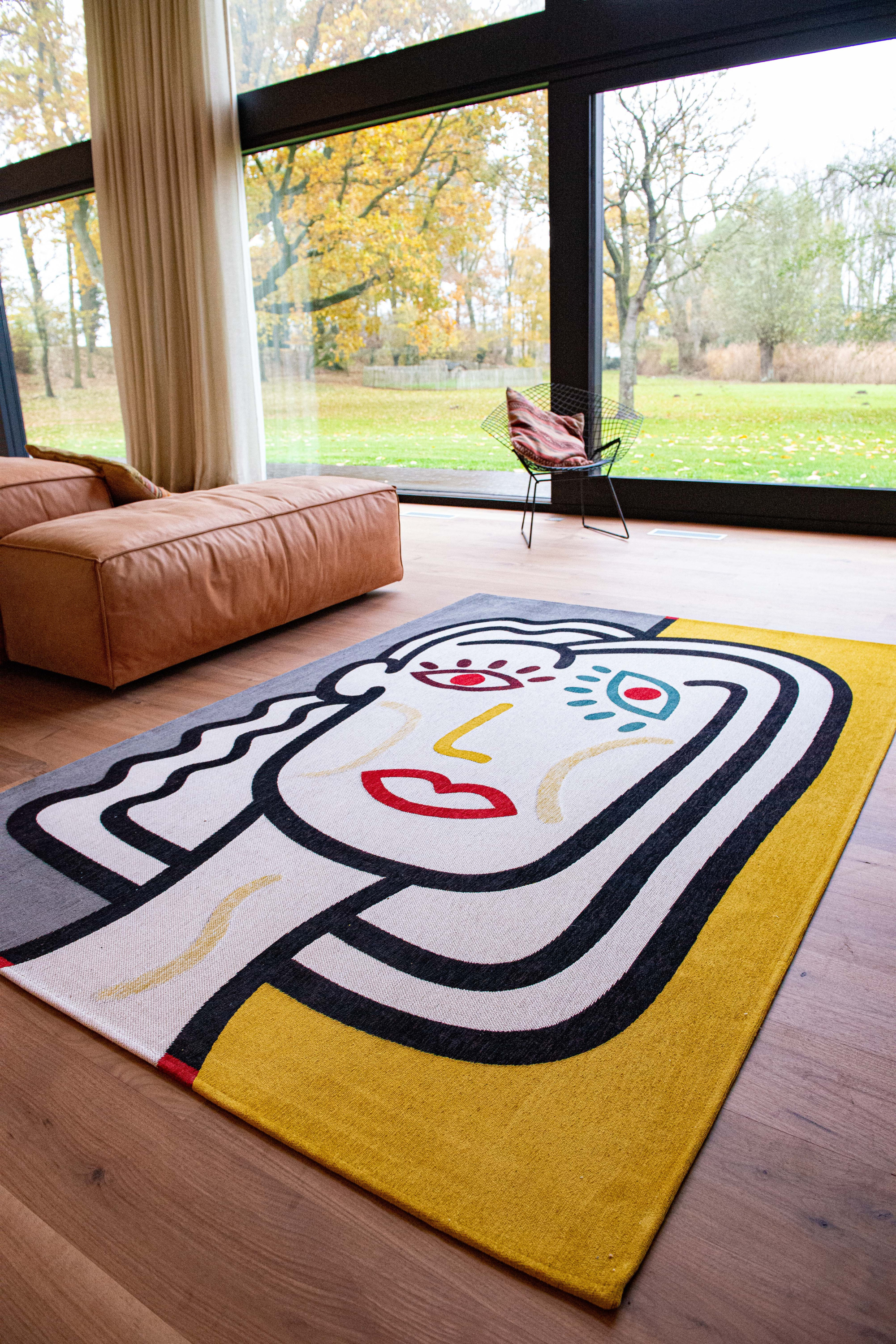yellow, blue and red rug with an abstract face