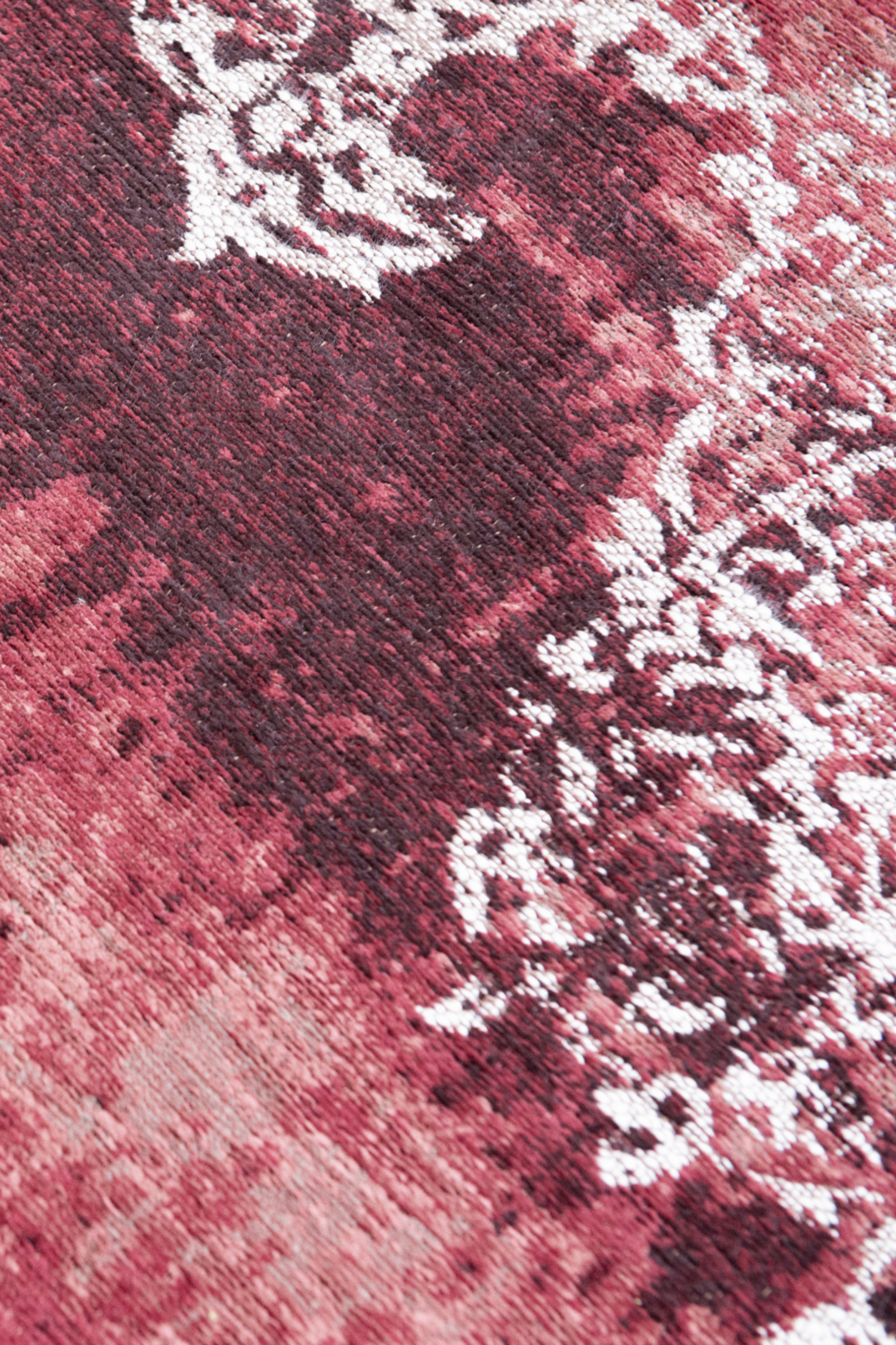 Red vintage Kirman-inspired rug with faded medallion pattern