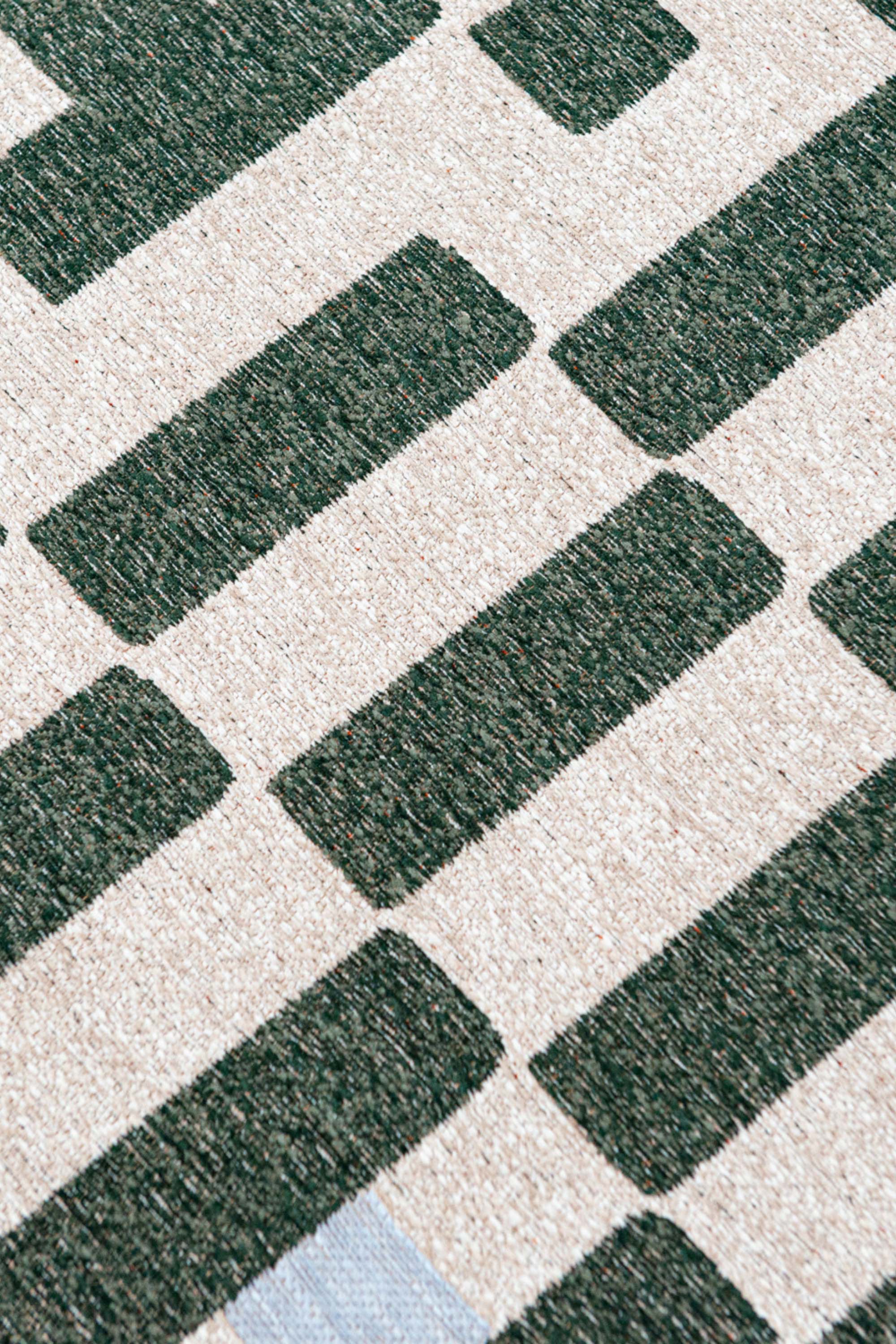 Abstract geometric rug with green, orange, and white tones