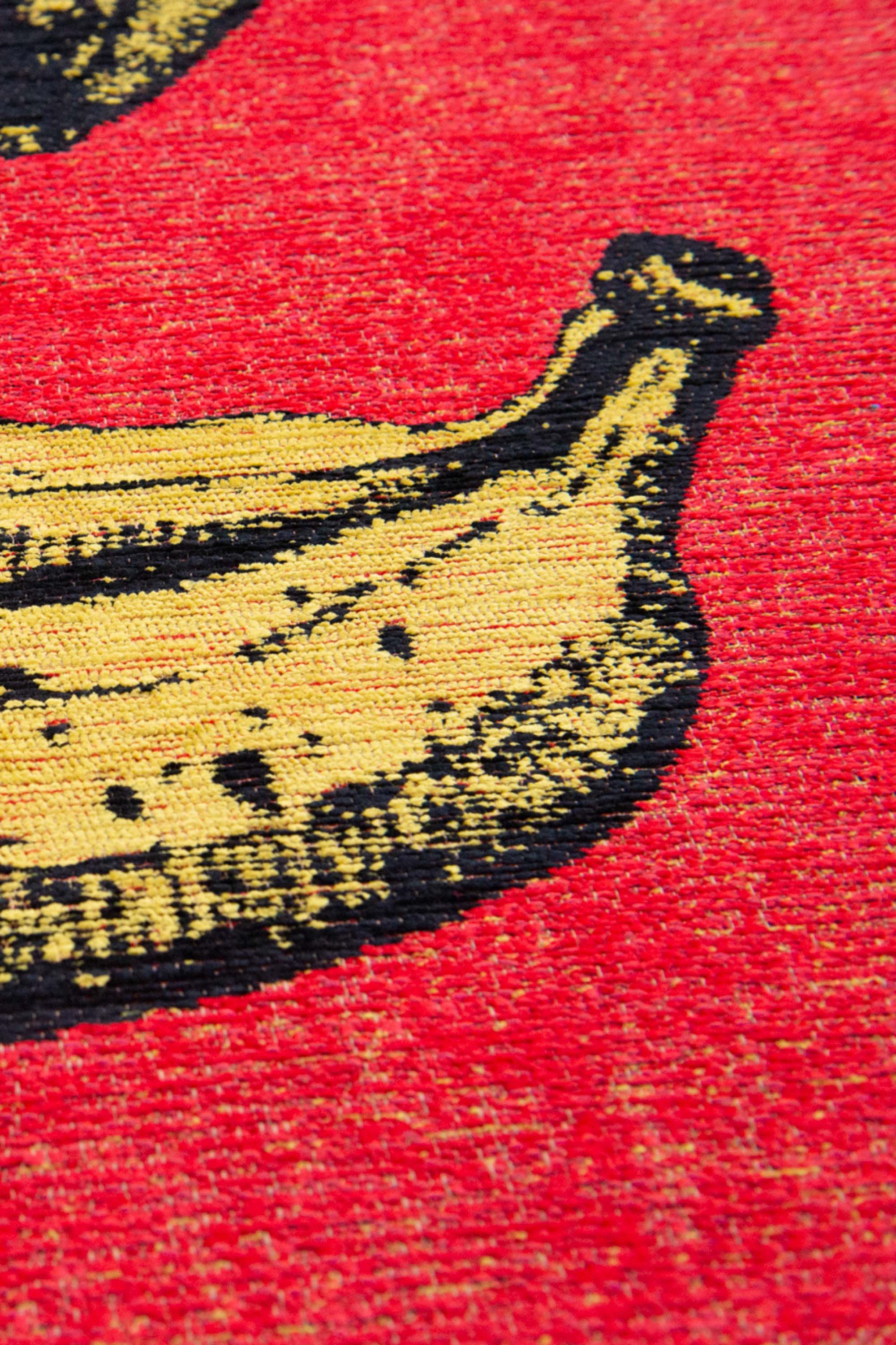 Modern red rug with repeated banana motif