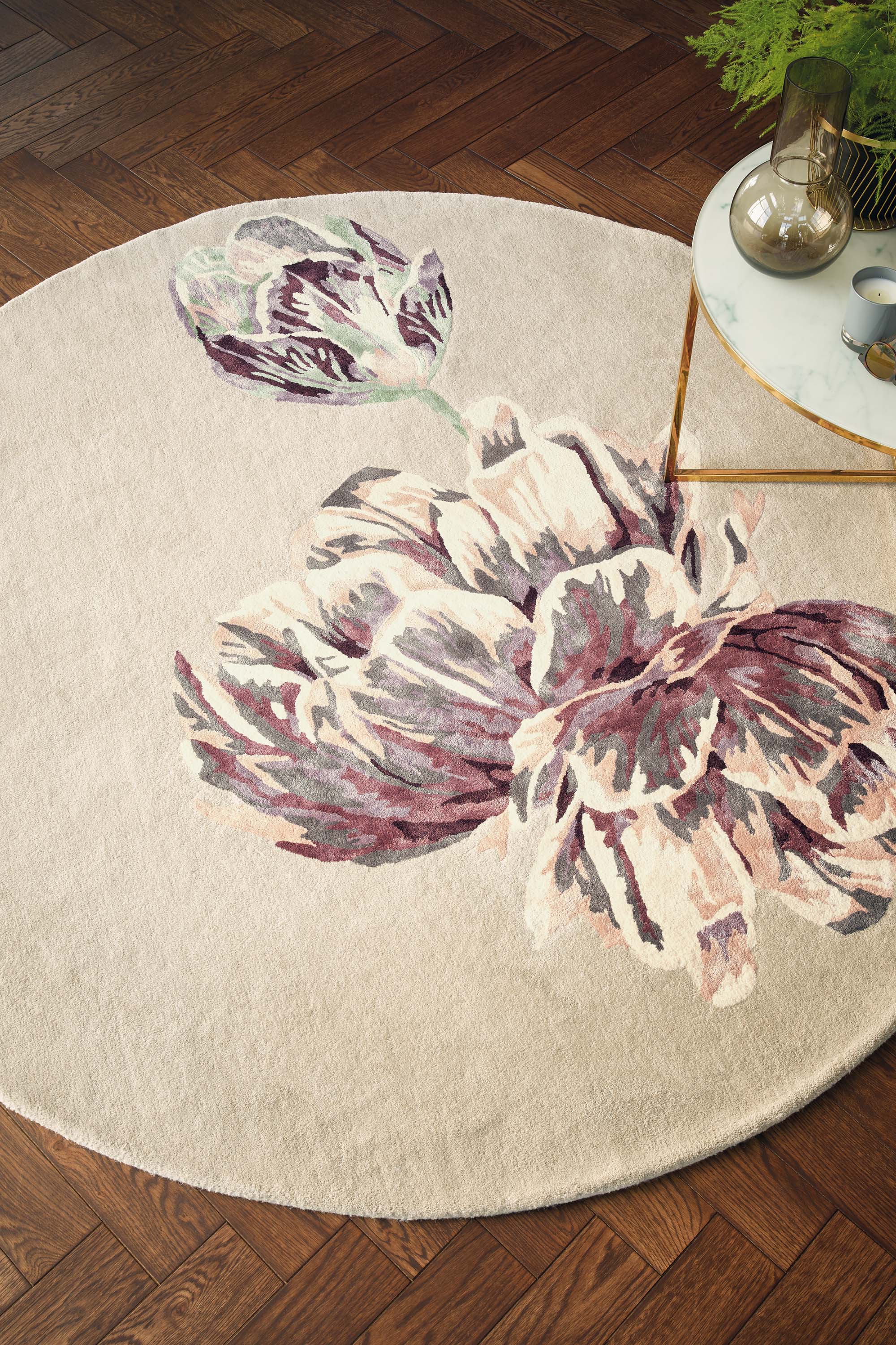 Round beige rug with large white and purple flower motif