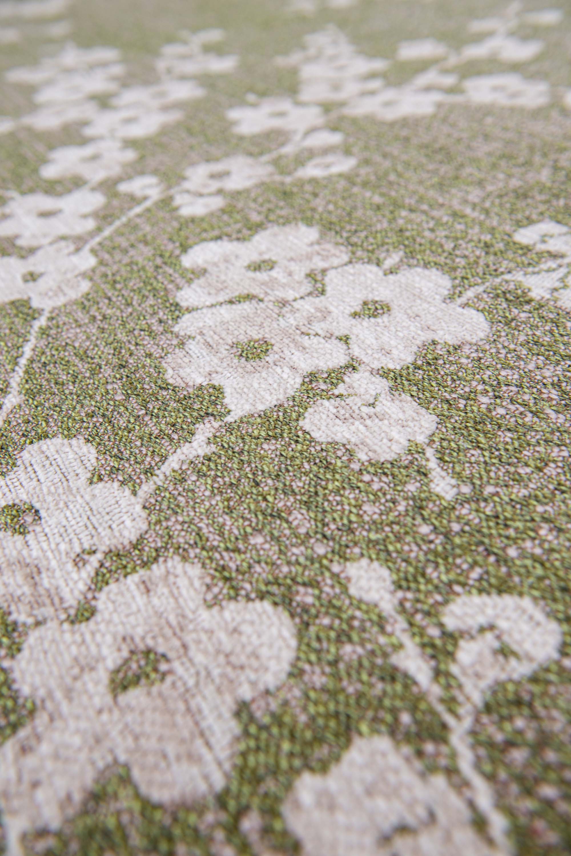 Modern abstract rug with subtle green floral pattern