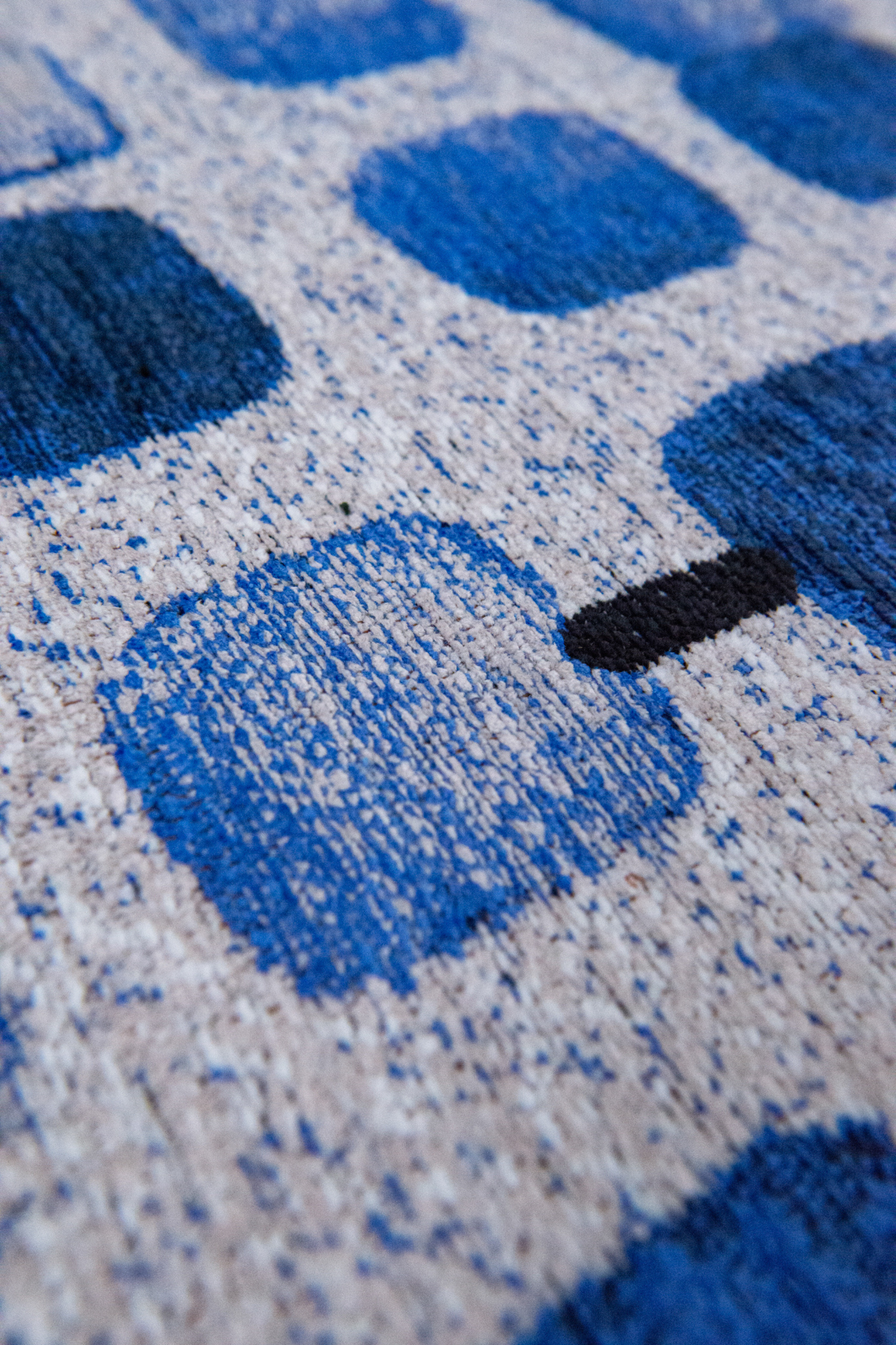 Modern blue rug with repeated peach motif pattern