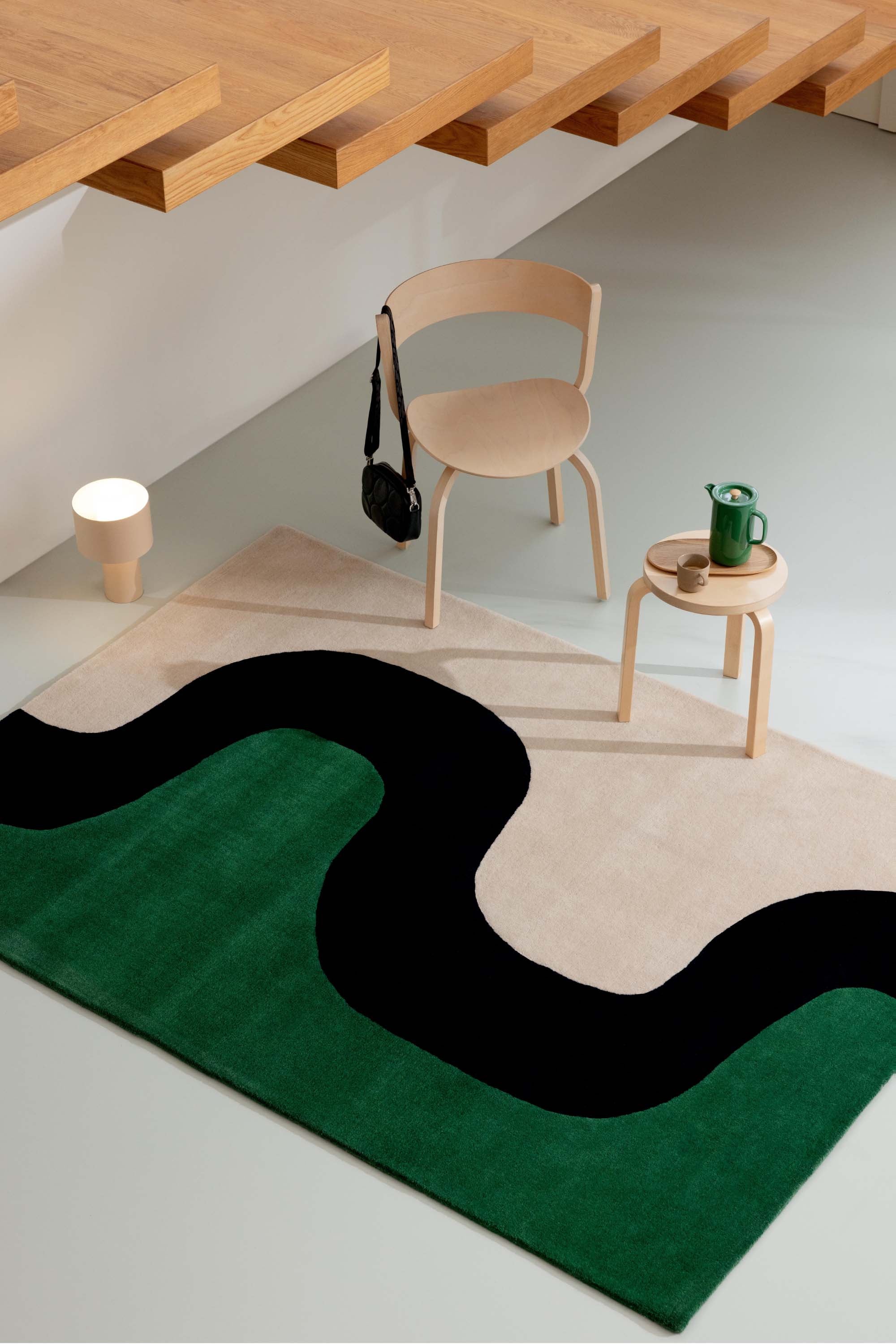 Beige and green rug with cream blue pattern