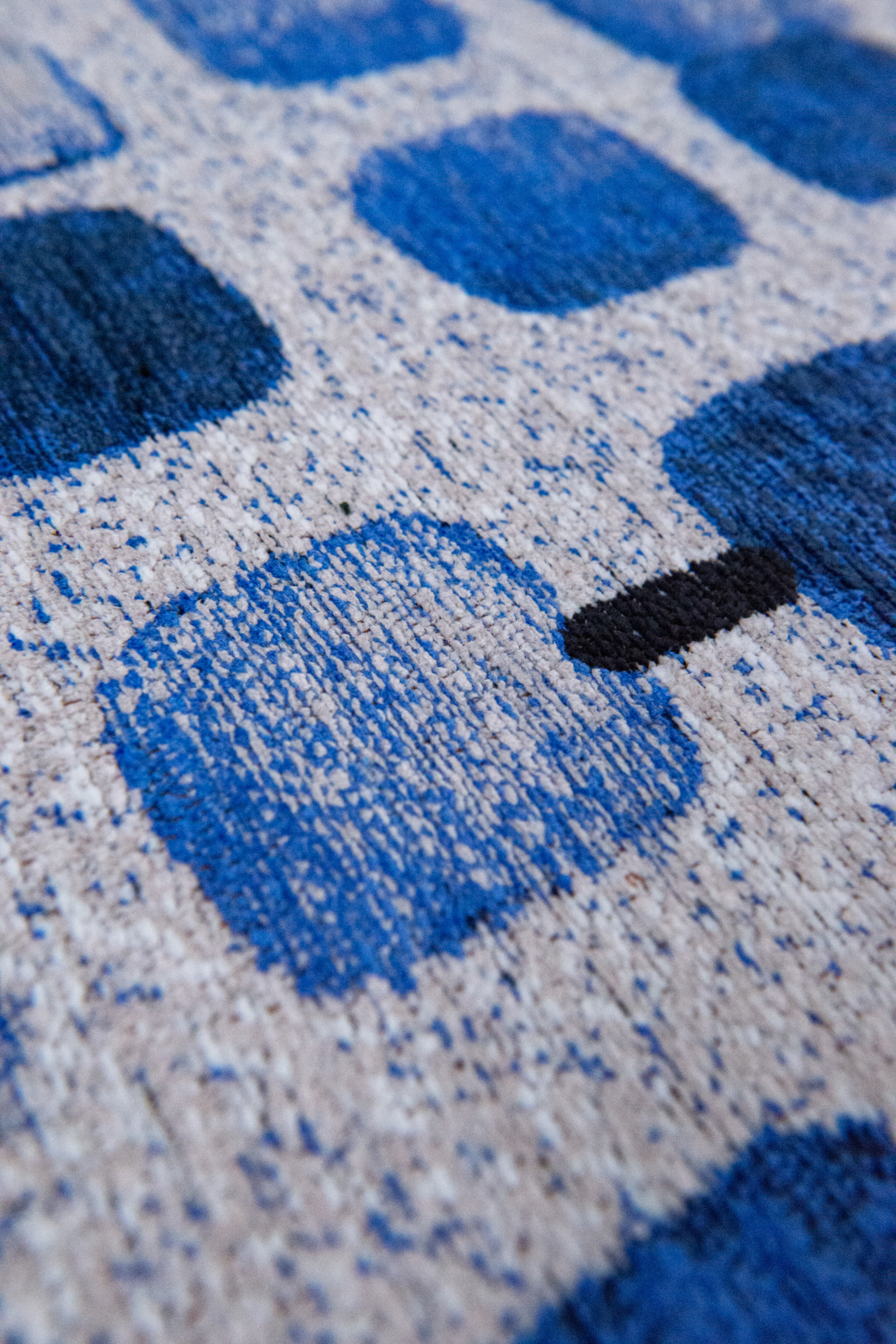 Modern blue circle rug with repeated peach motif pattern