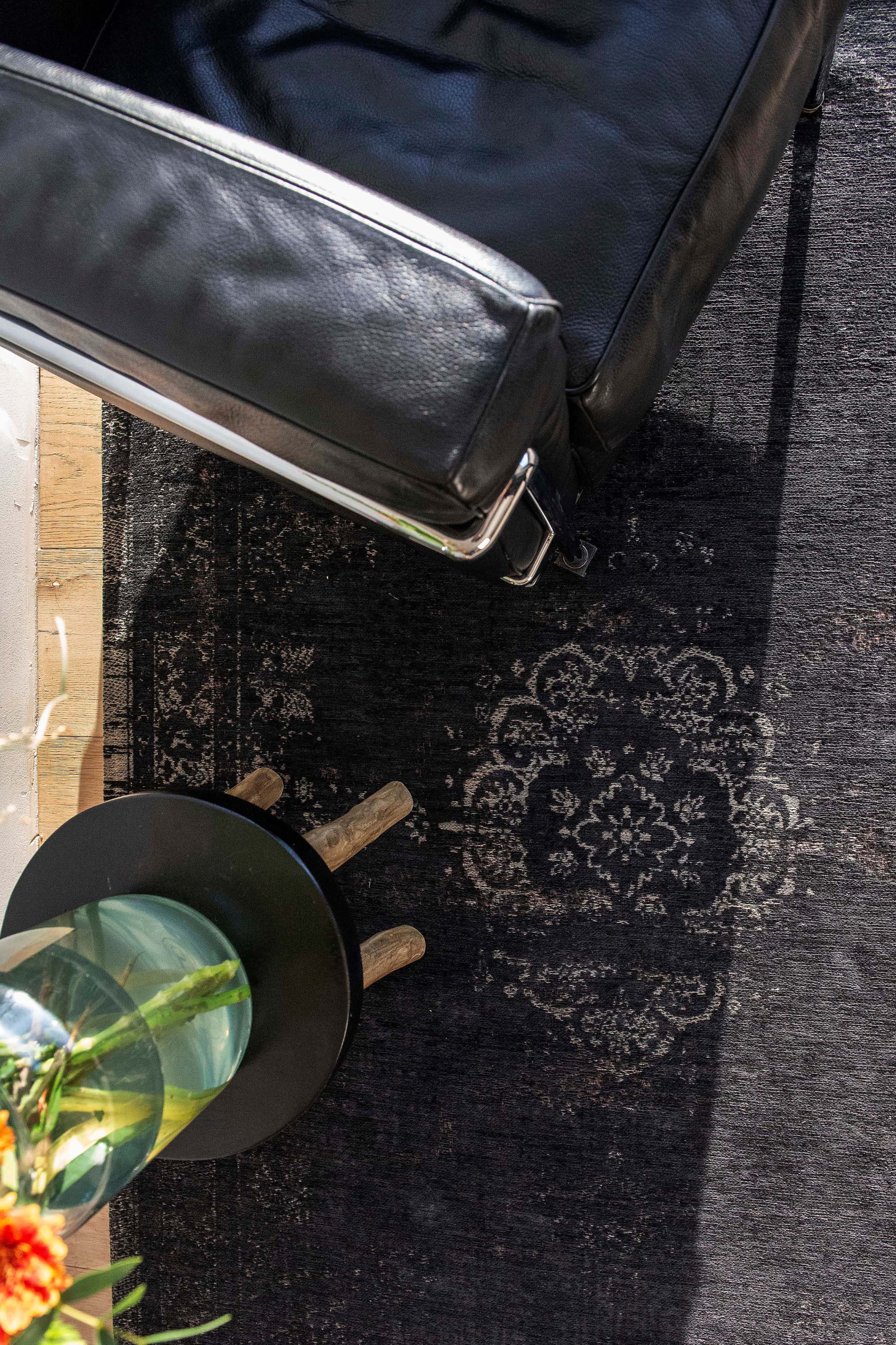 Black flatweave rug with faded persian design