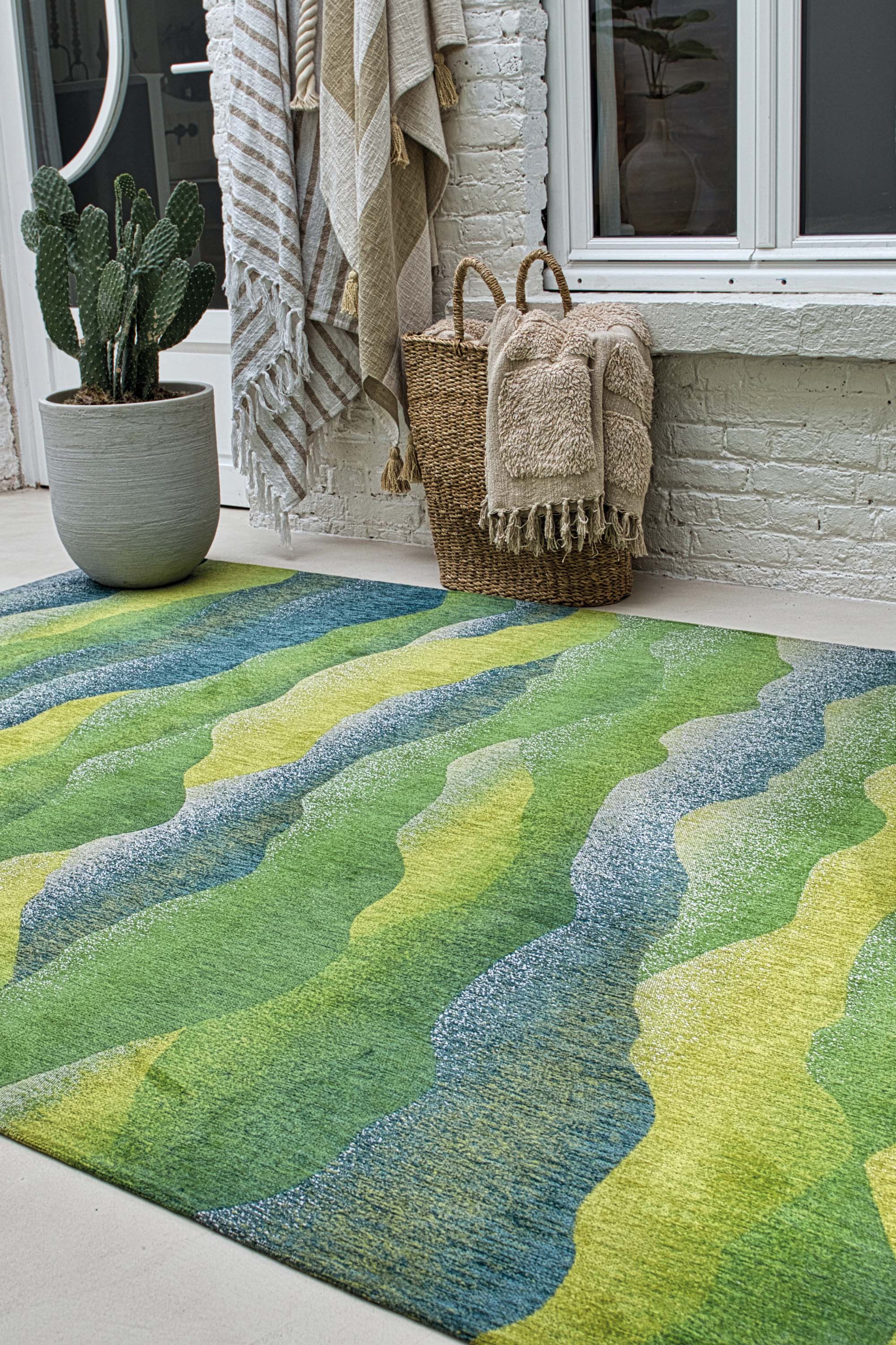 Modern circle rug with green abstract mountain range pattern