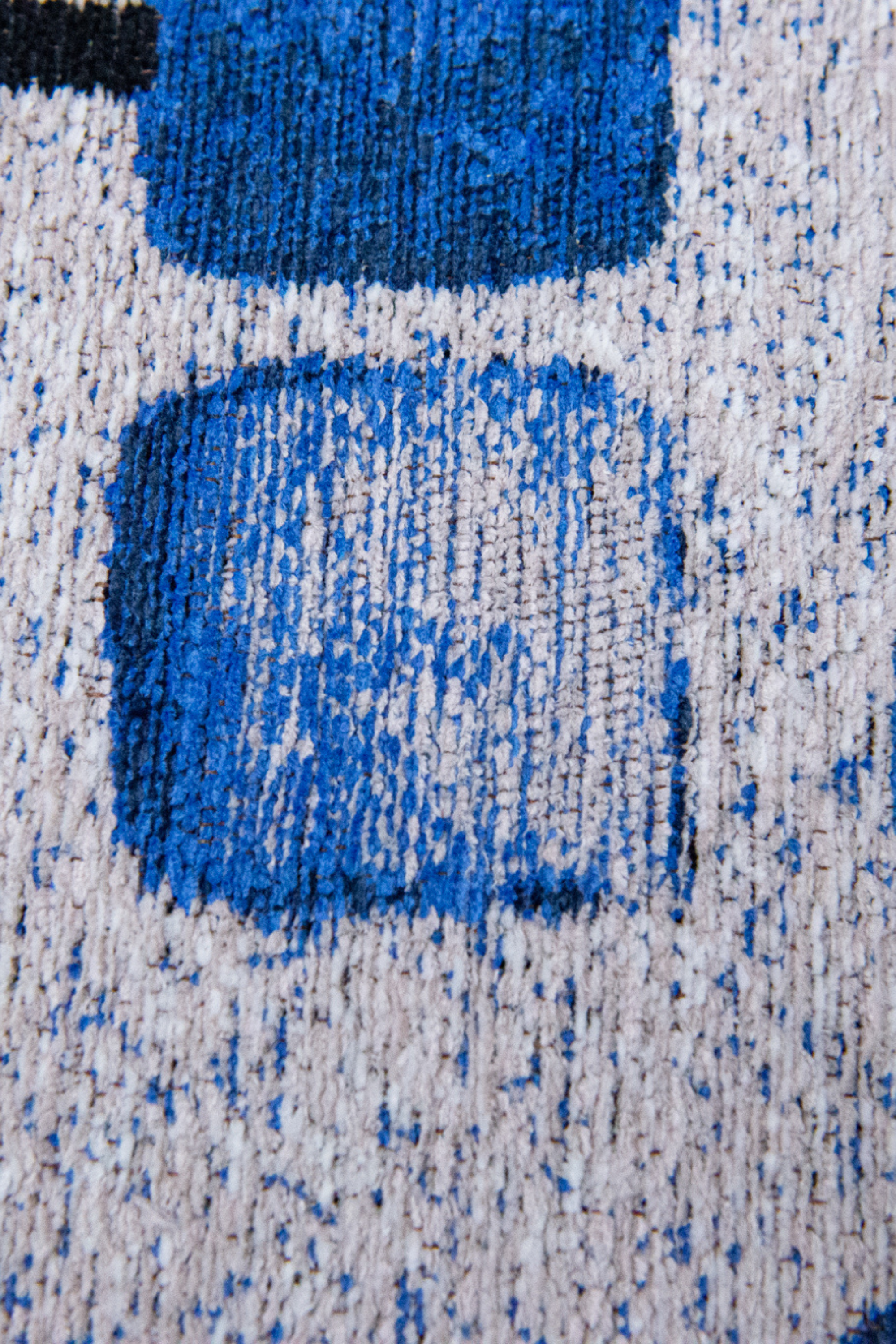 Modern blue rug with repeated peach motif pattern