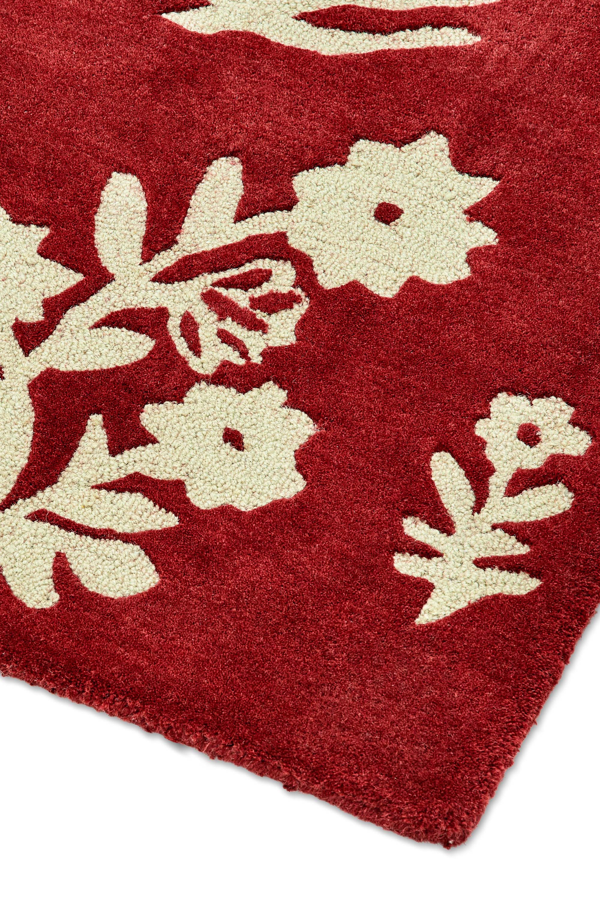 Red rug with cream floral motif