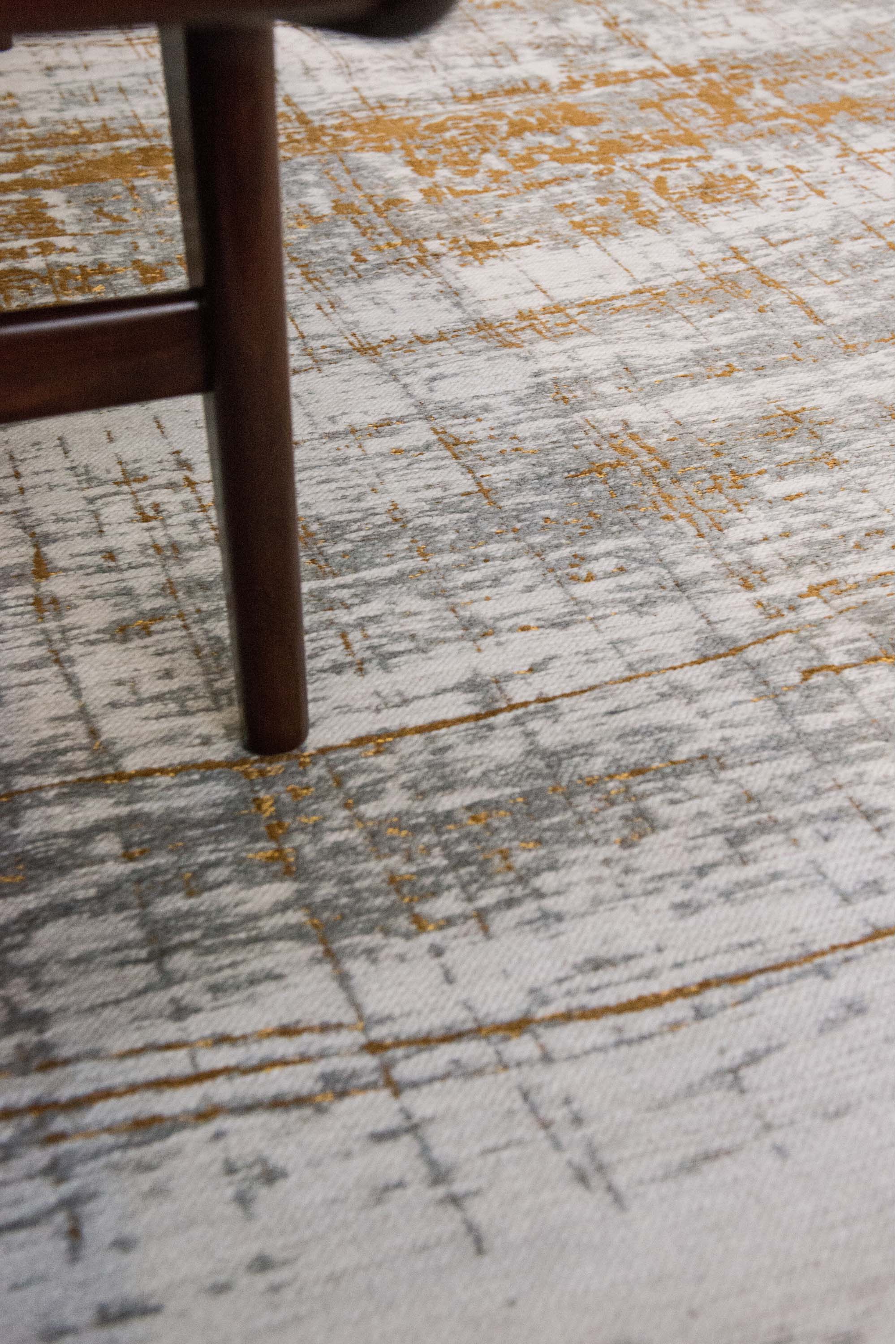 White flatweave rug with grey and yellow abstract pattern